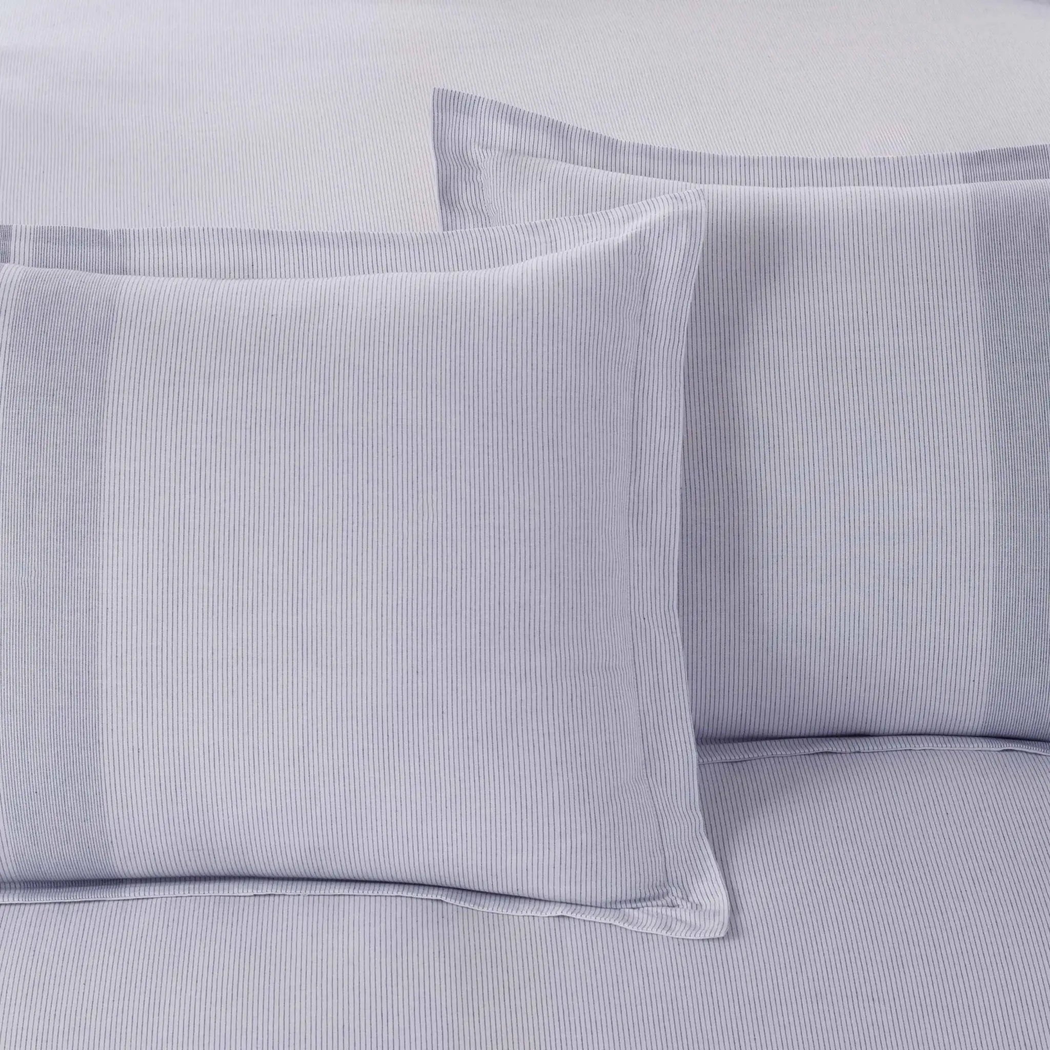 Two light gray striped pillow shams on a matching gray striped bedsheet, shown in a clean, close-up product shot.