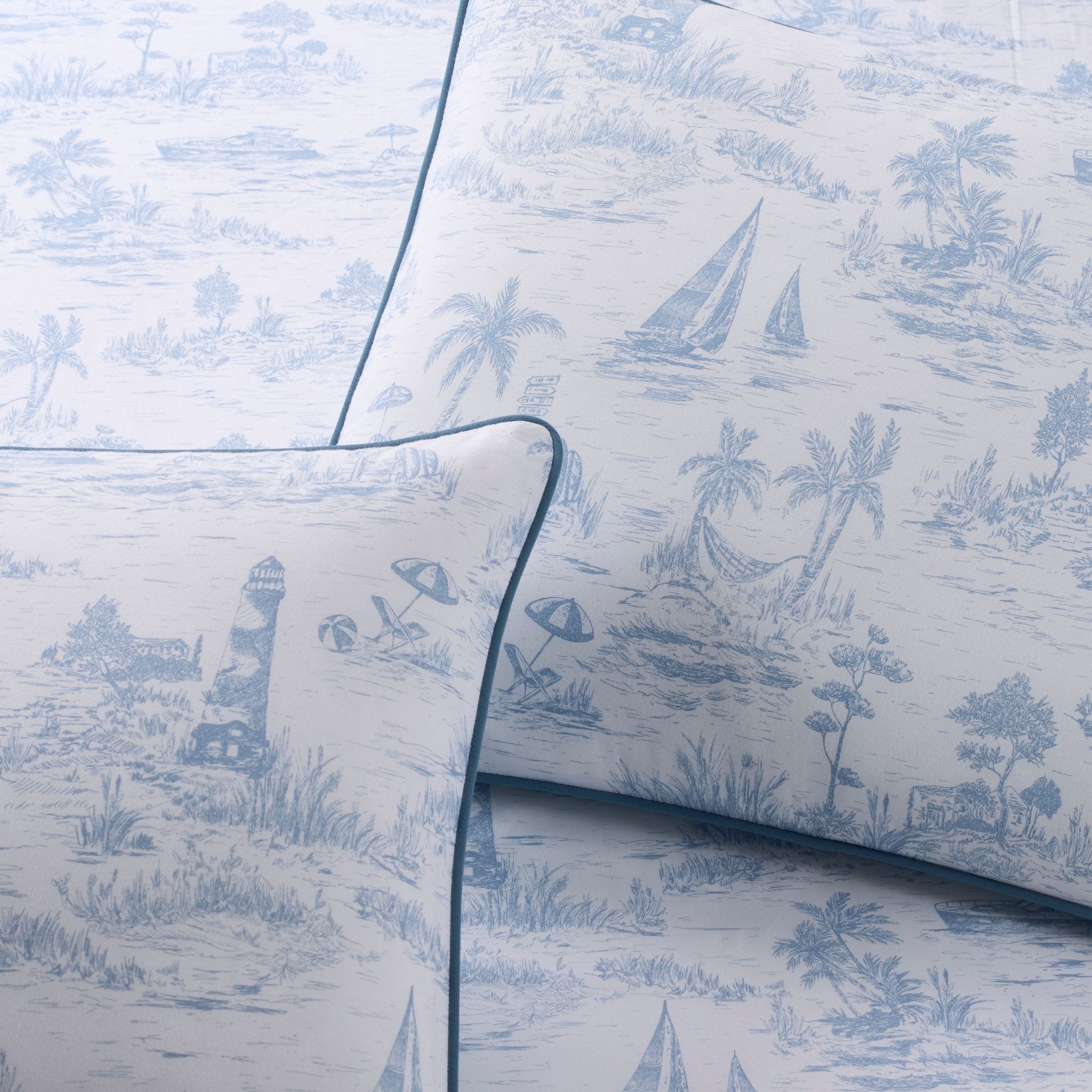 Pillow shams with blue beach-themed design on a white background