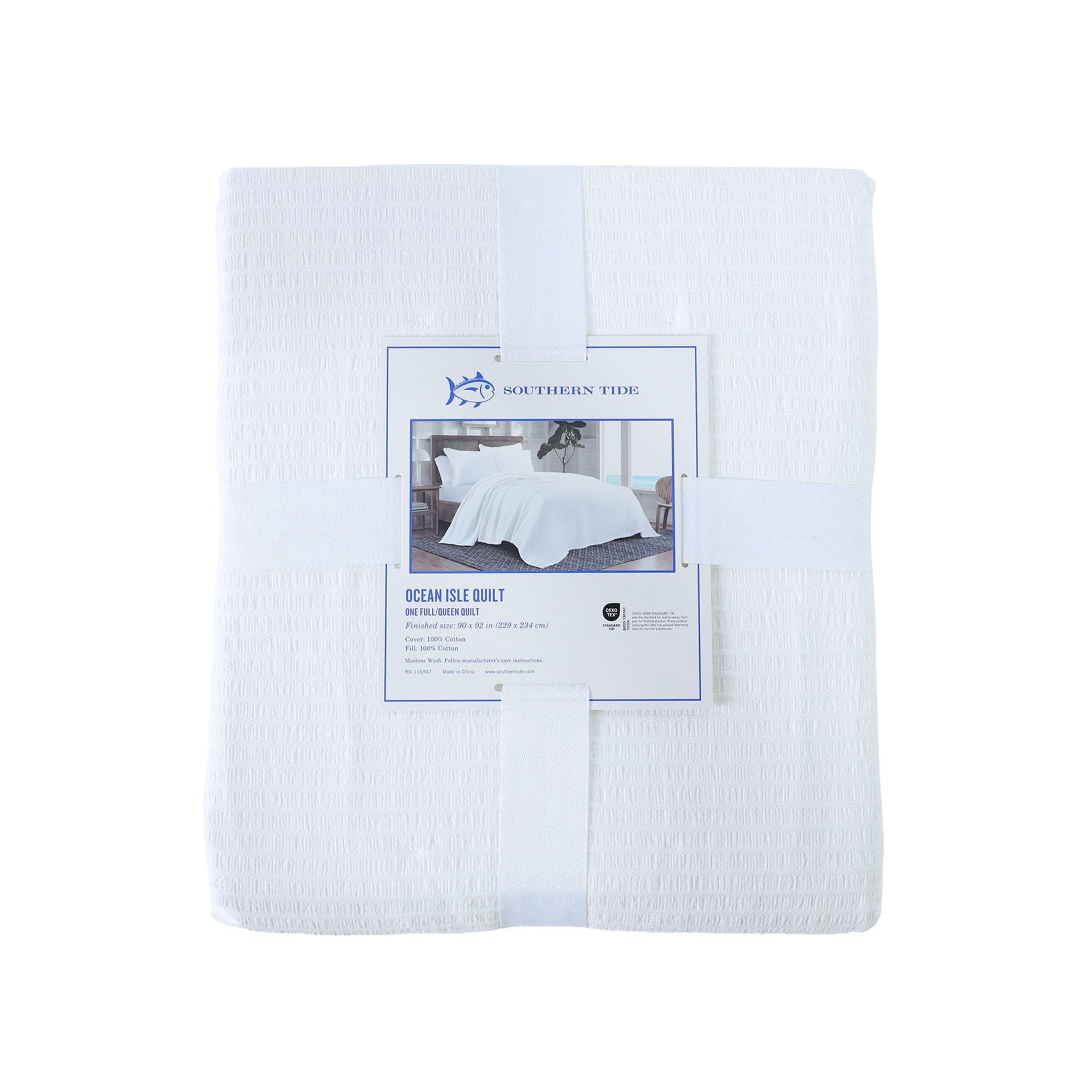Back view of white quilt with packaging on a white background