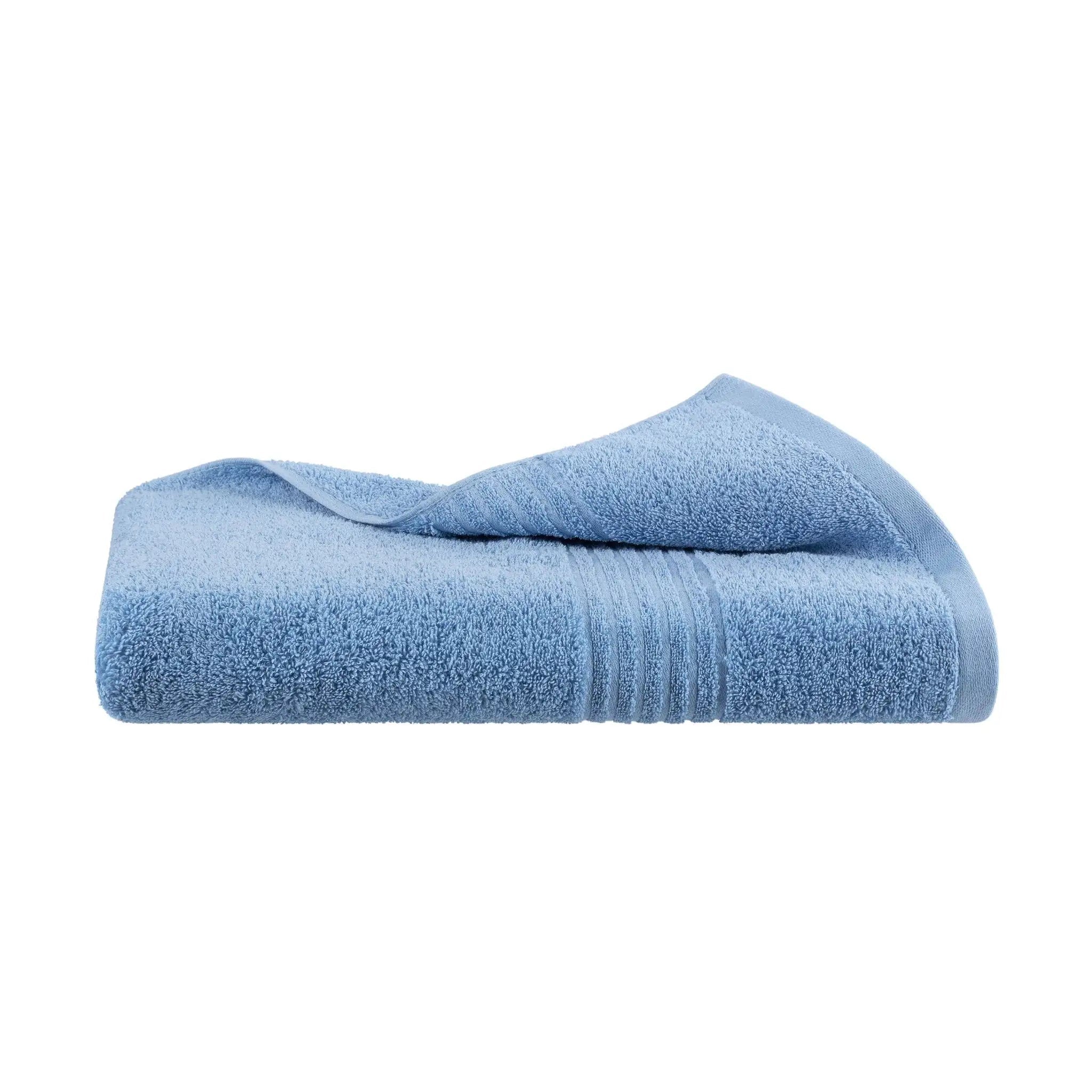 Folded blue bath towel on a white background