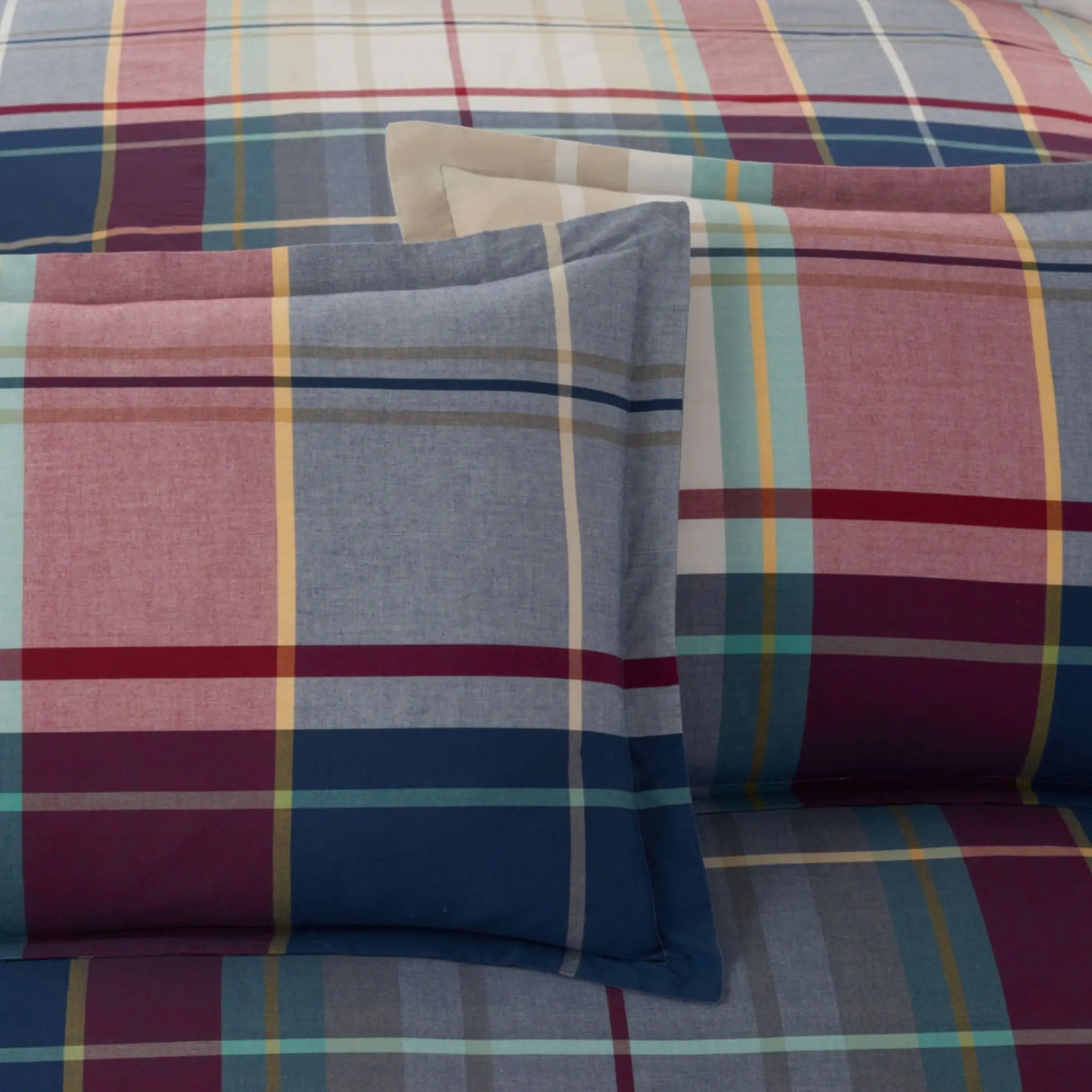 Plaid patterned pillow shams and comforter.