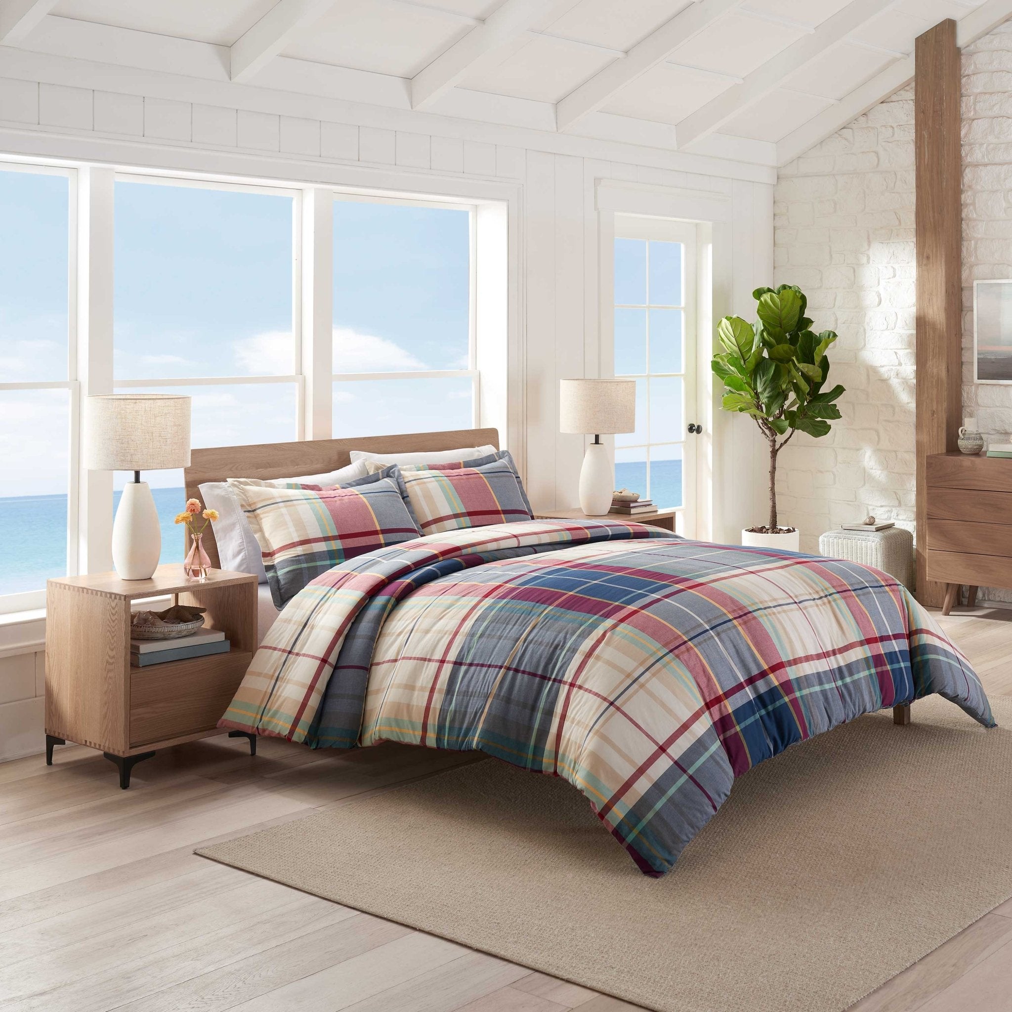 Bedroom with plaid comforter set.