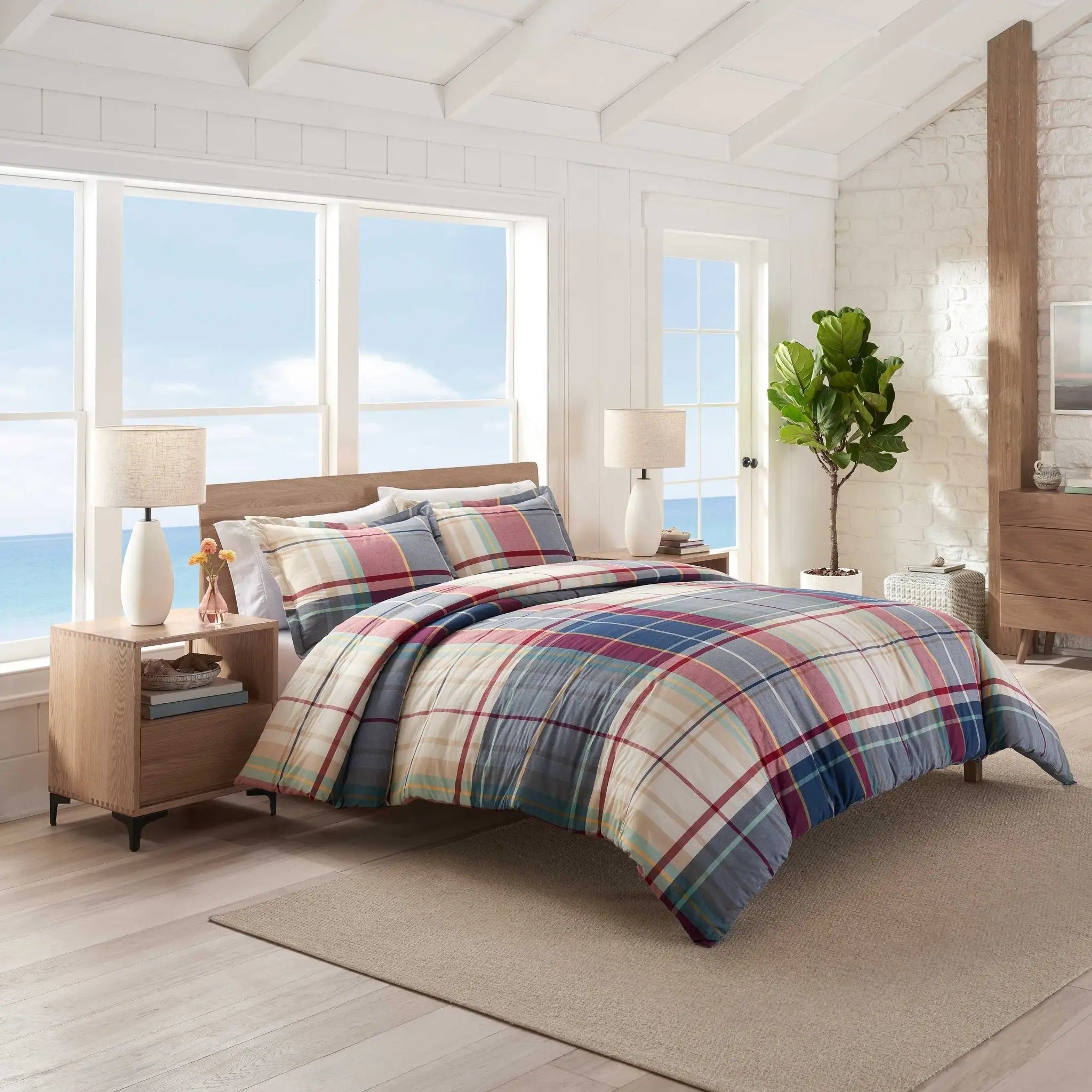 Bedroom with plaid comforter set.