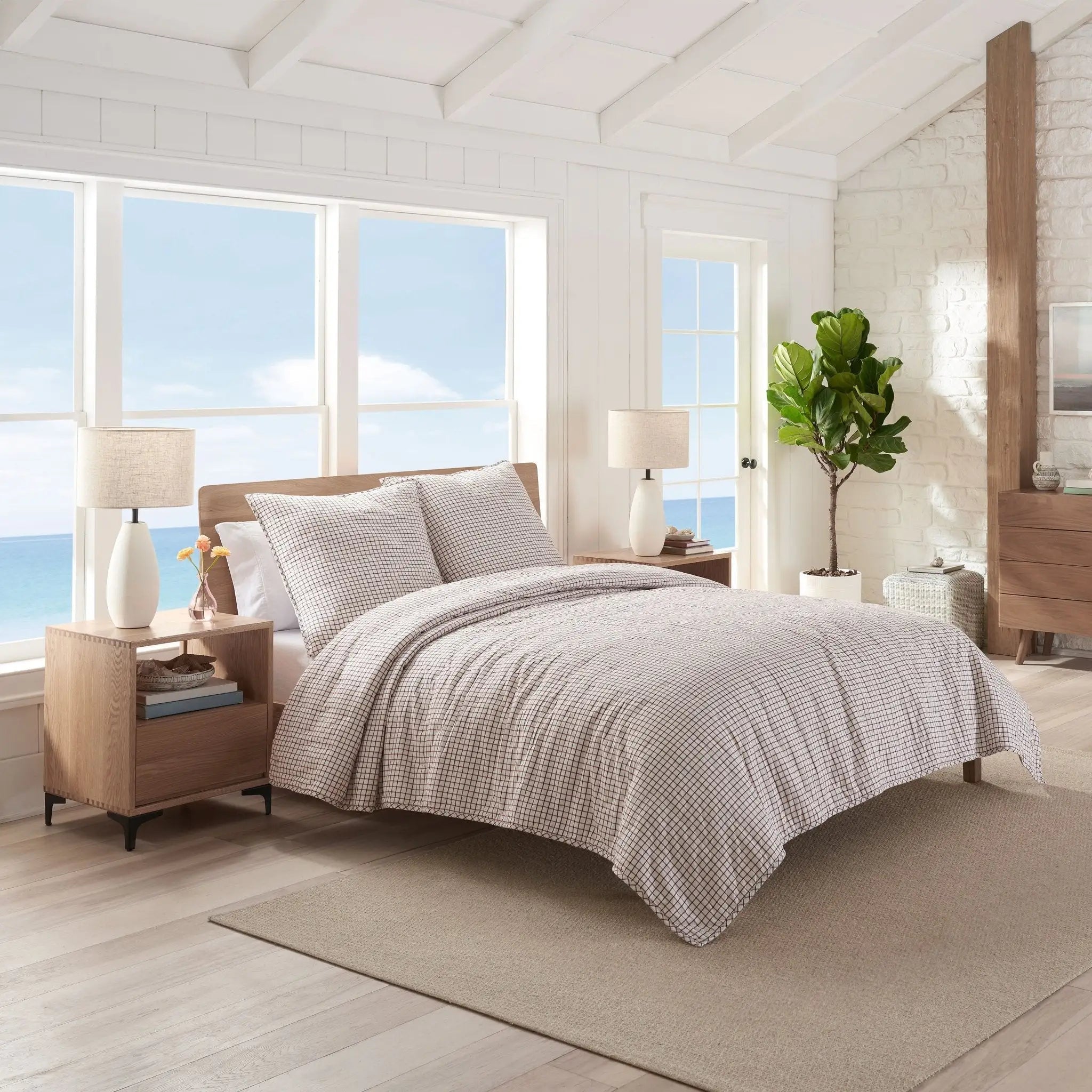 Modern bedroom with quilt and euro on a bed.