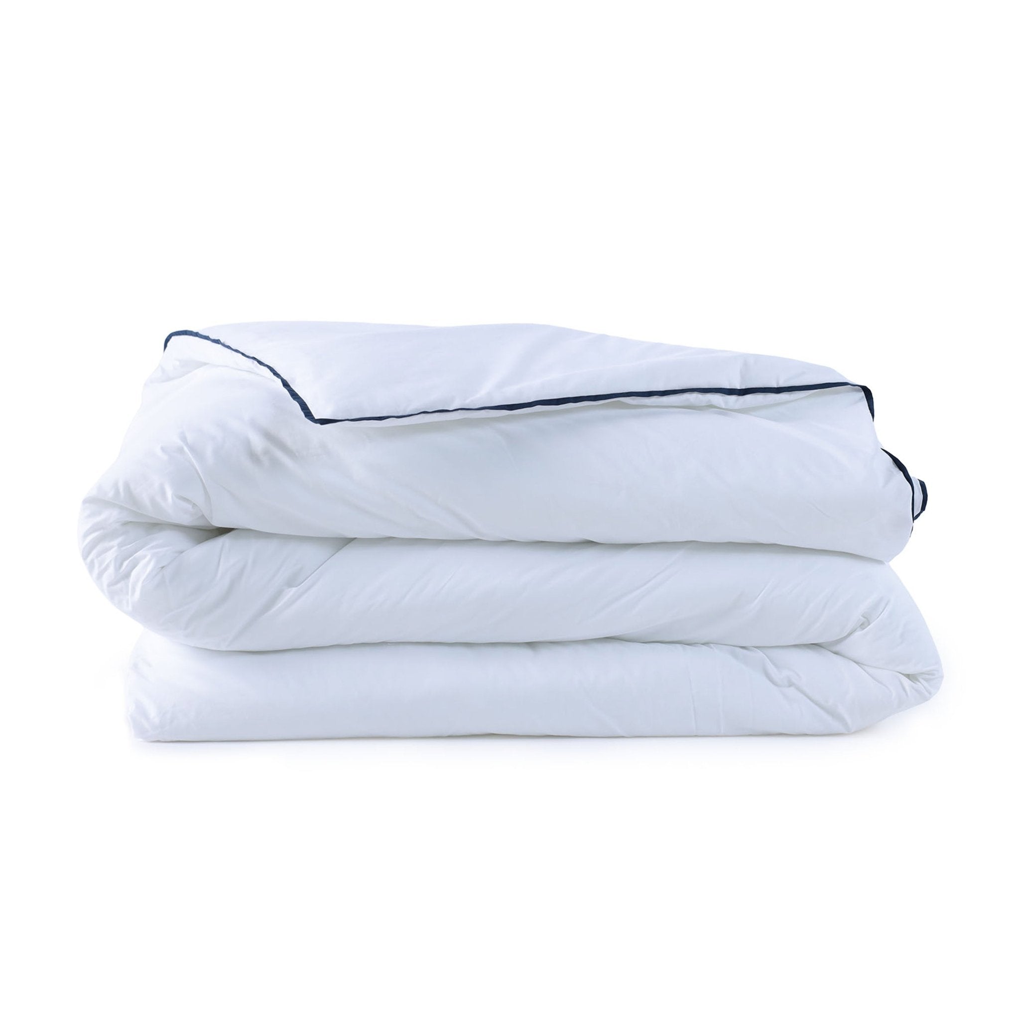 Folded white comforter with black piping on a white background