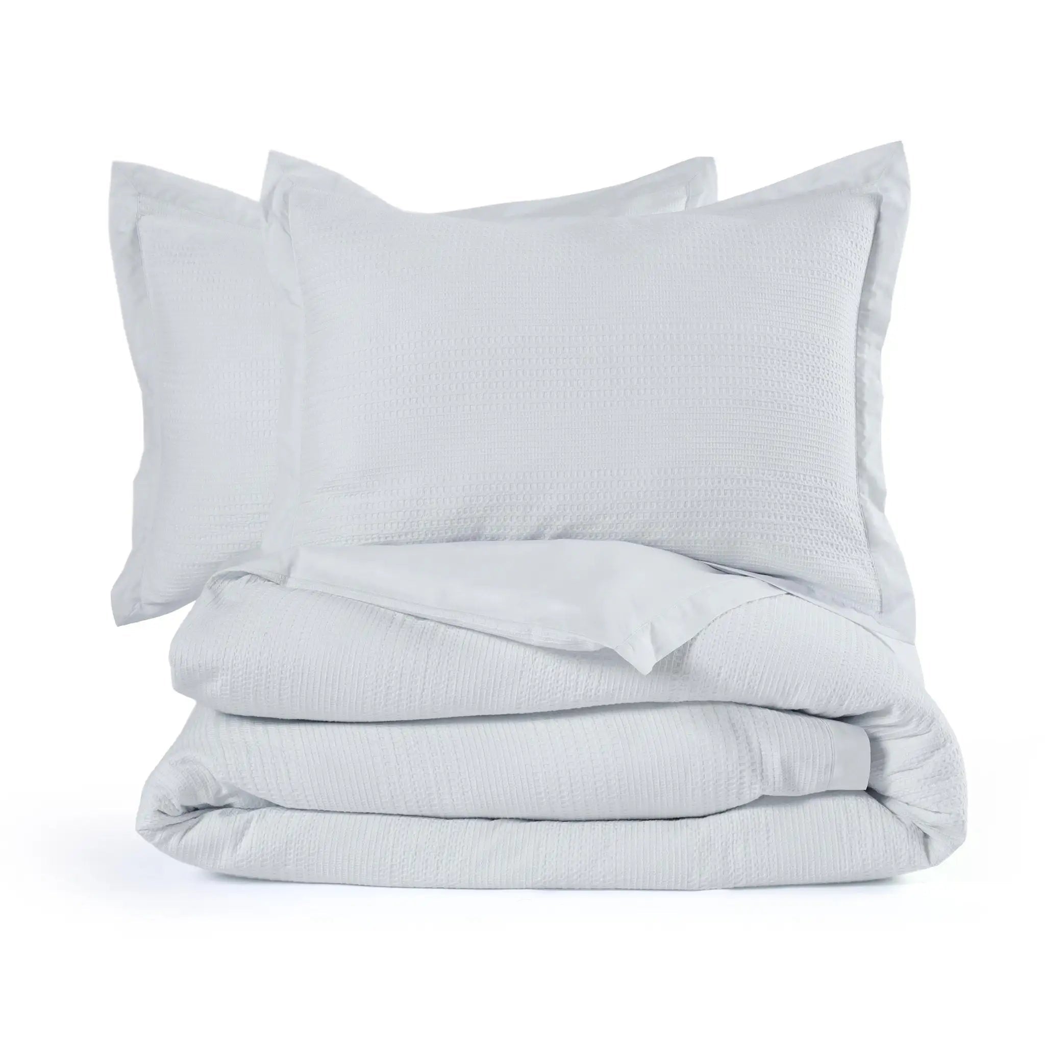 A folded comforter set consisting of a gray textured comforter and two matching pillow shams, on a seamless white background.
