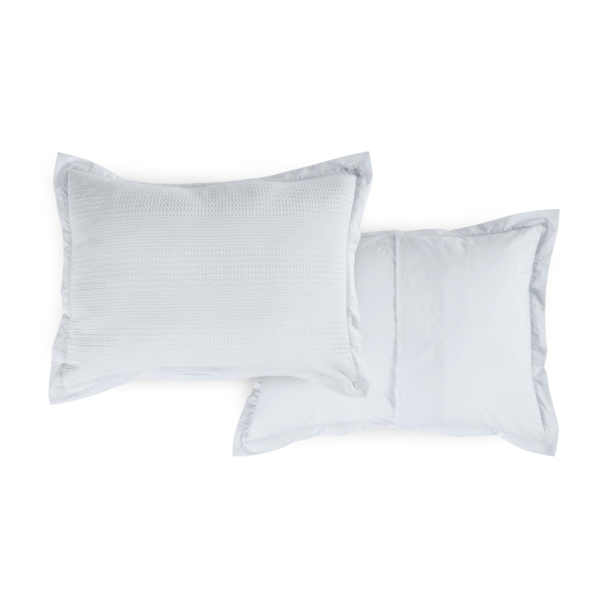 Two grey shams on a white background, featuring a subtle patterned front and a coordinating reversible side.