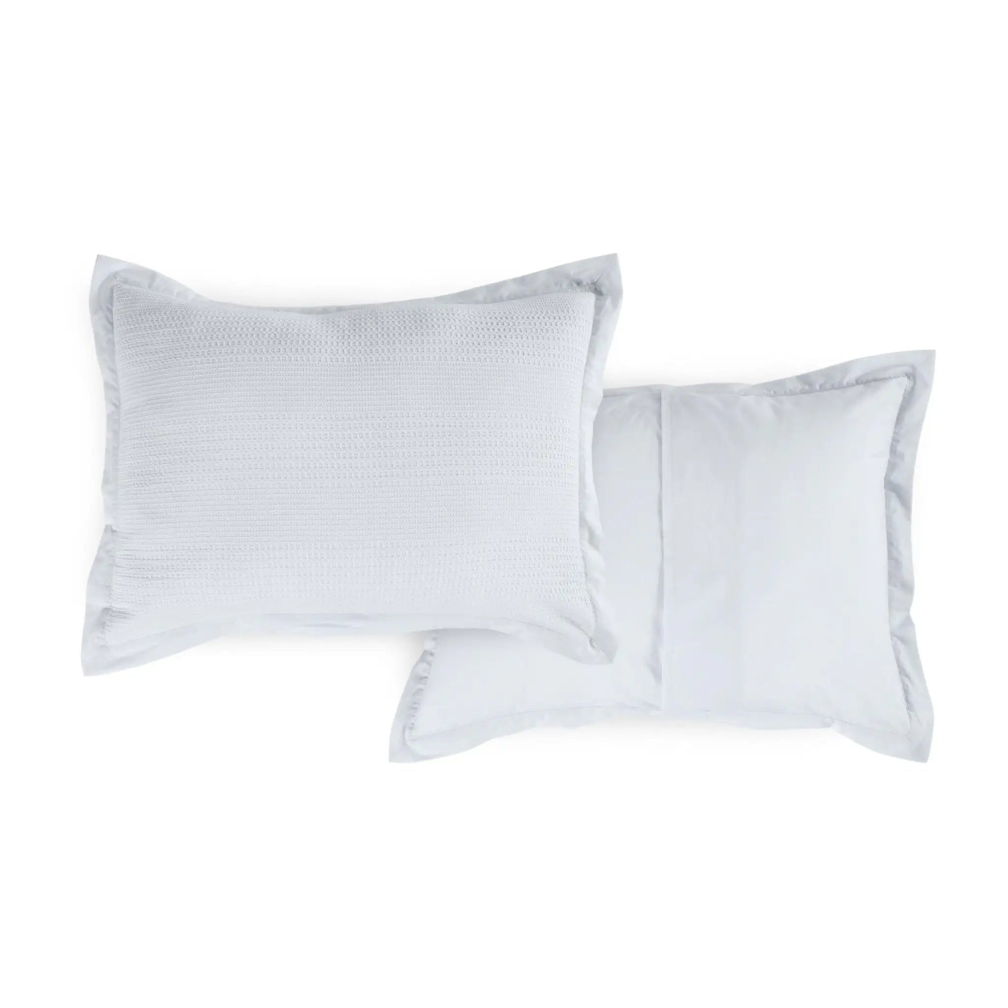 Two grey pillow shams with a subtle pattern on a white background