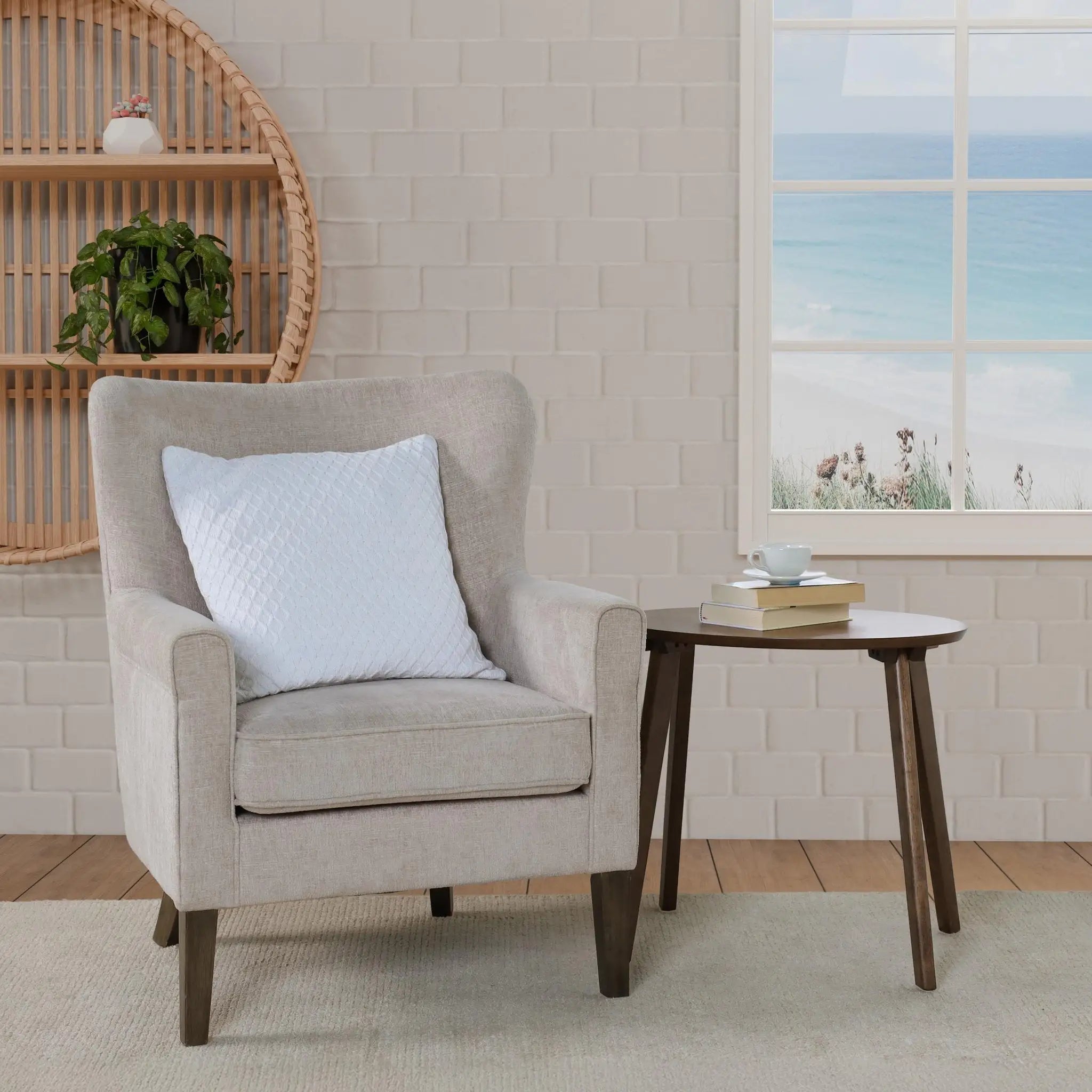 A light beige upholstered armchair with a white textured throw pillow.