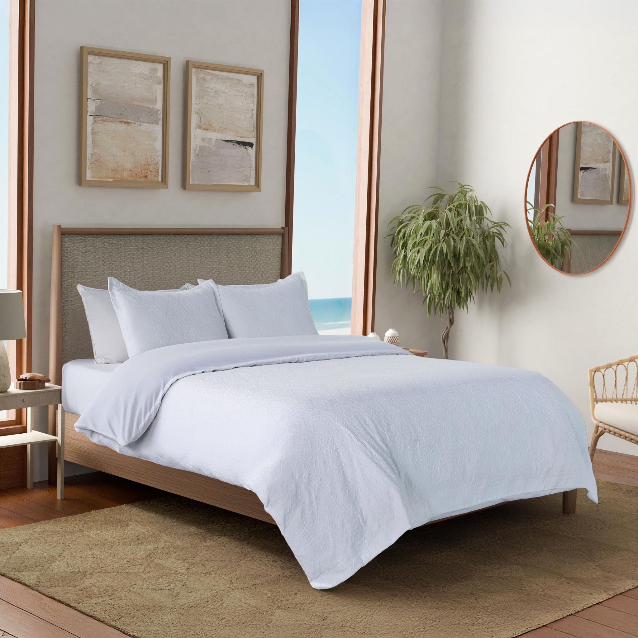 Bedroom featuring a neatly made bed with a white comforter and coordinating shams.