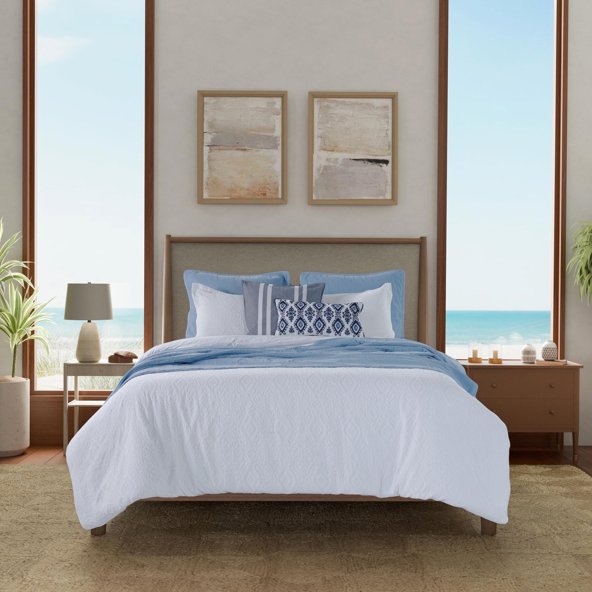 Bedroom with a bed featuring blue and white bedding.