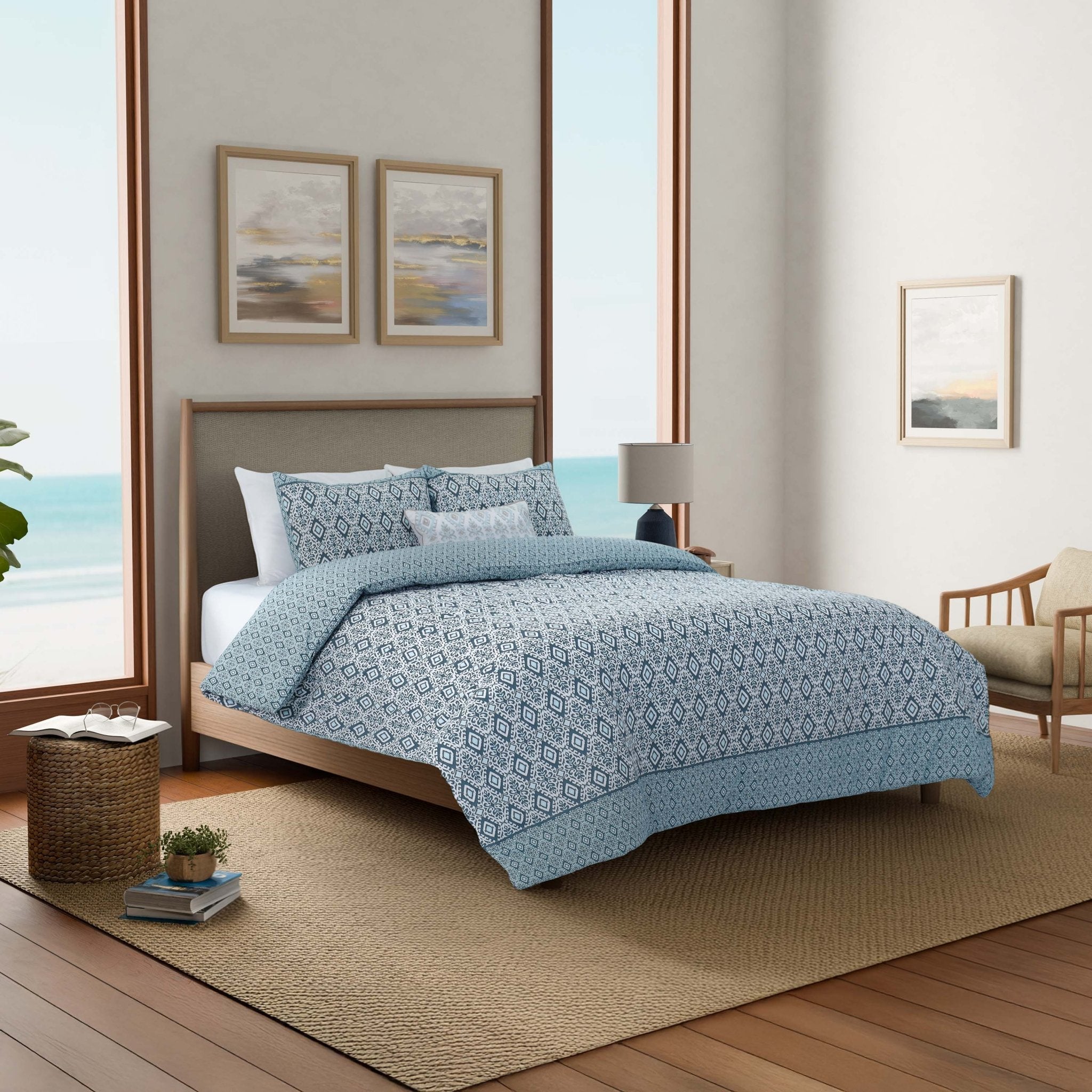 Bedroom with a bed covered in blue patterned comforter set.