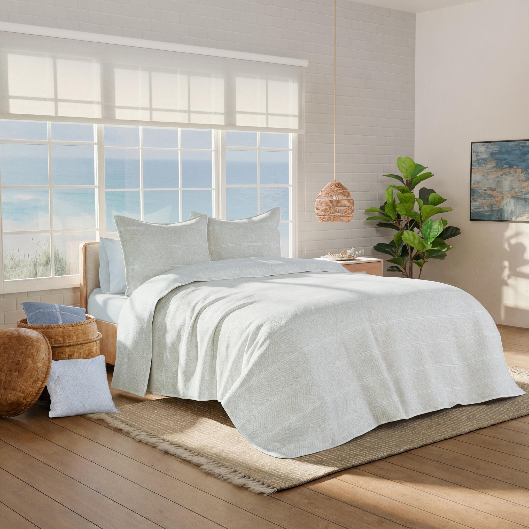 Neatly made bed with white bedding in a bright bedroom.