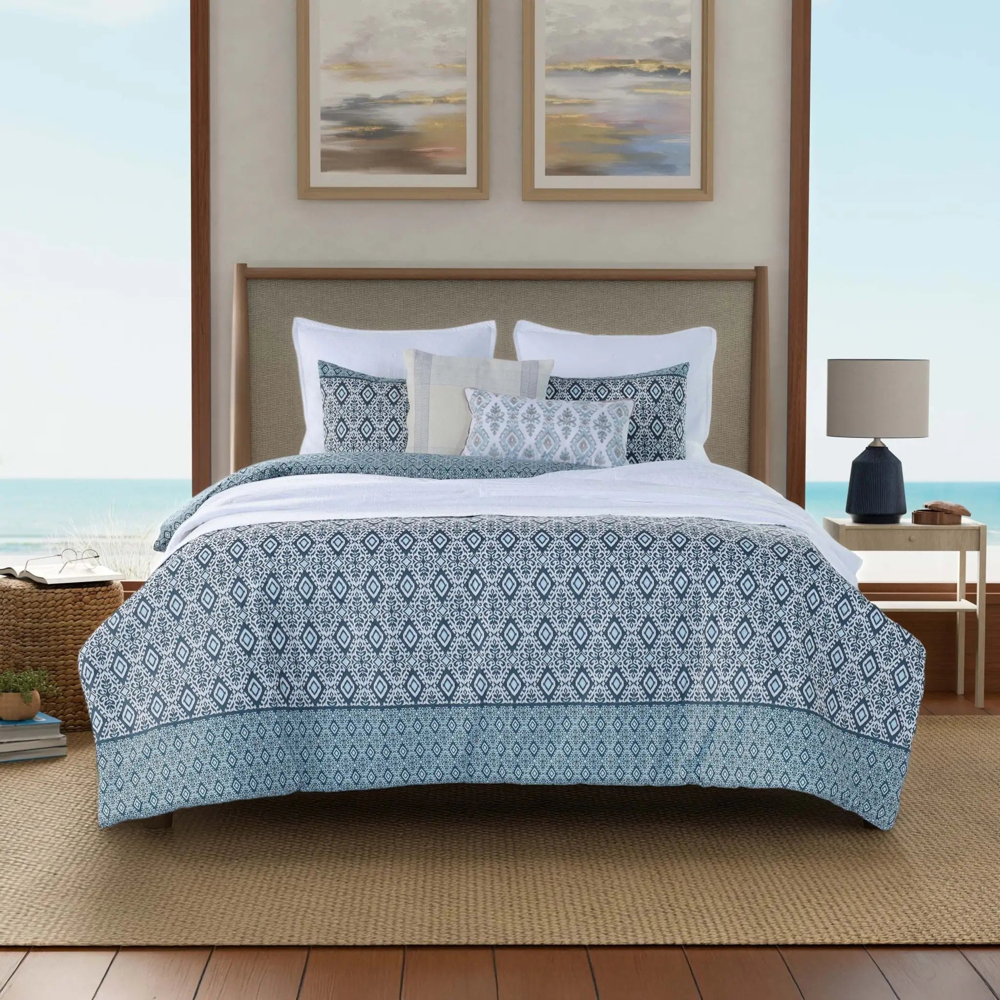 Bedroom with a bed featuring a blue and white patterned comforter.