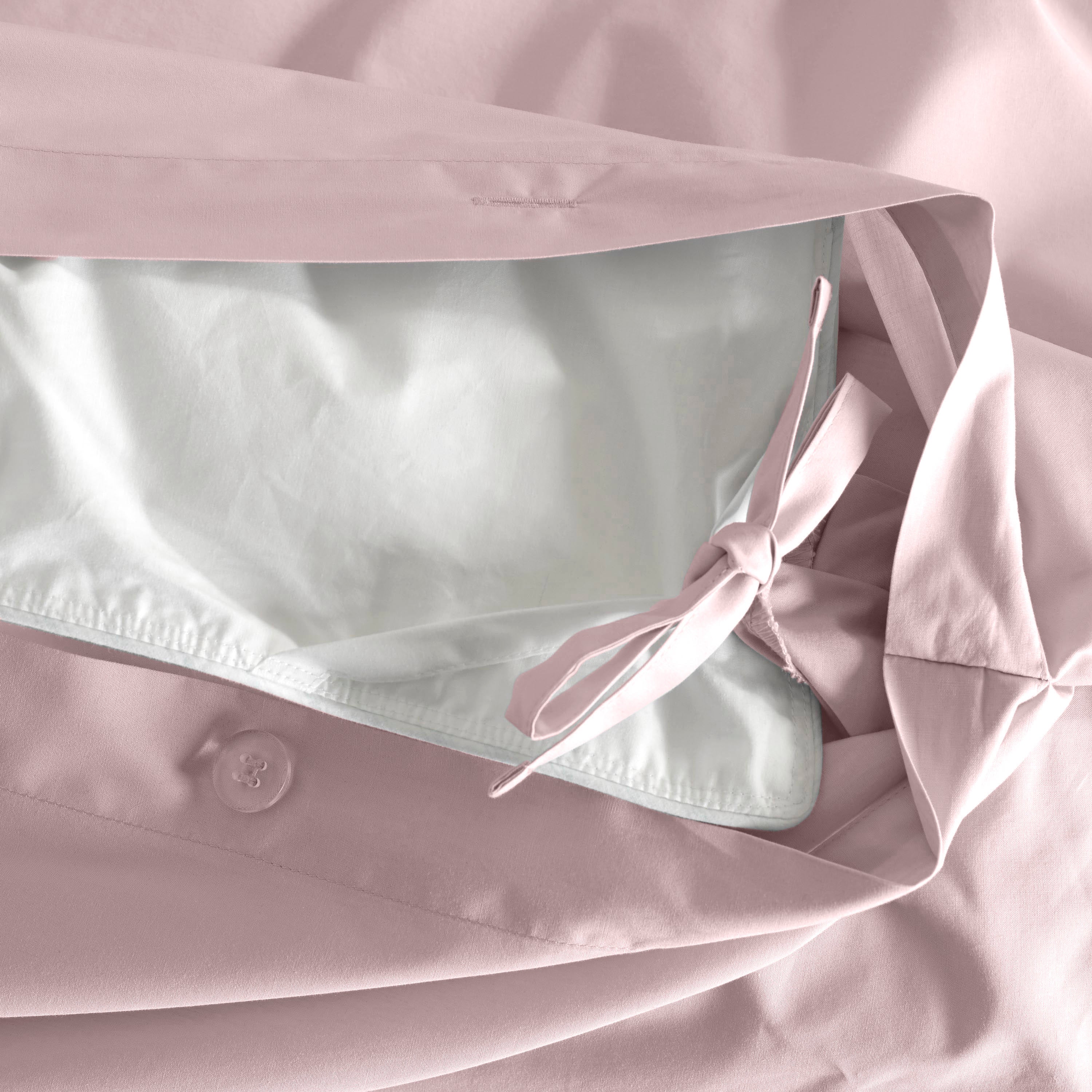 Duvet set featuring a soft pink exterior and a white interior with a tie closure and button detail.