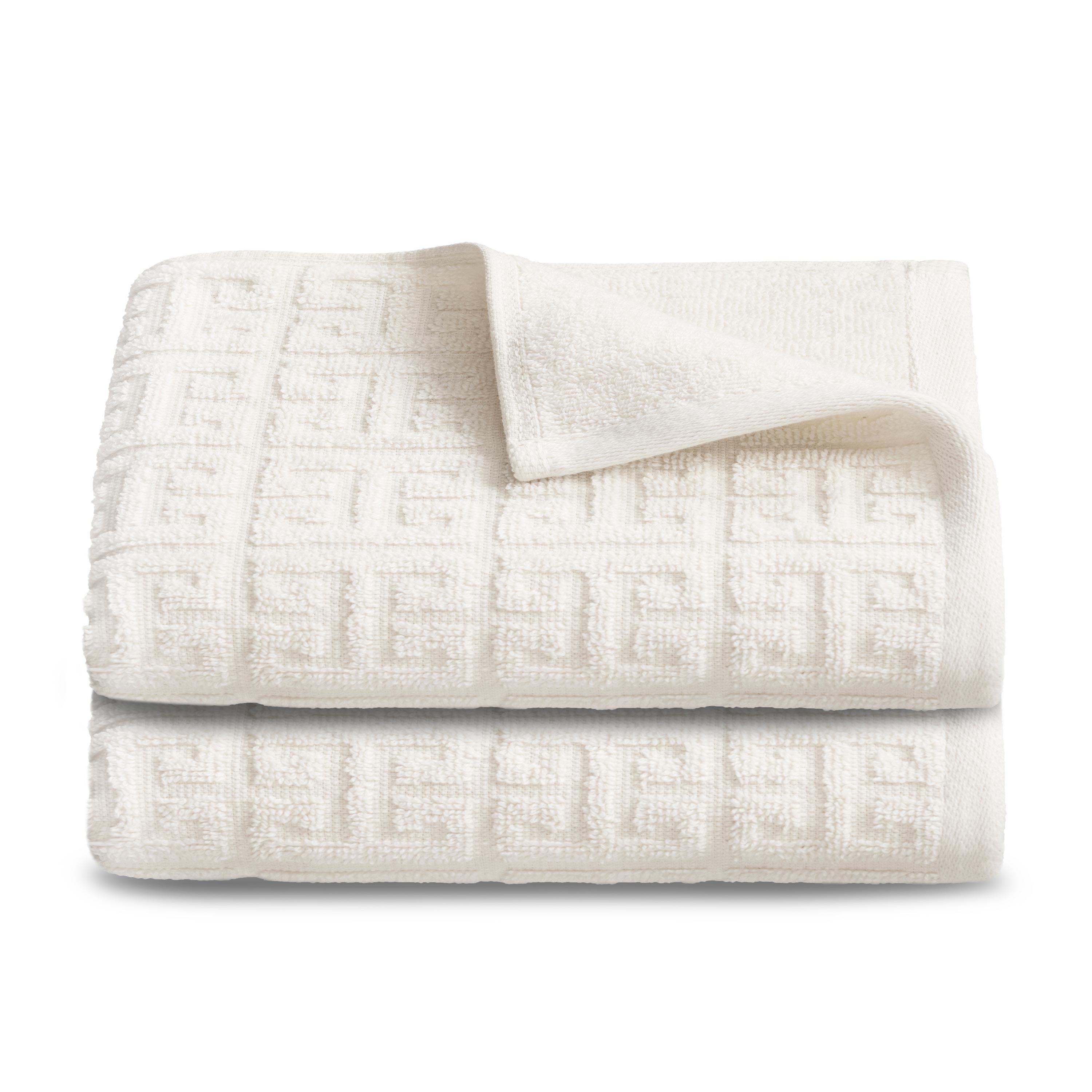 Two stacked hand towels in a textured white fabric with a geometric pattern.
