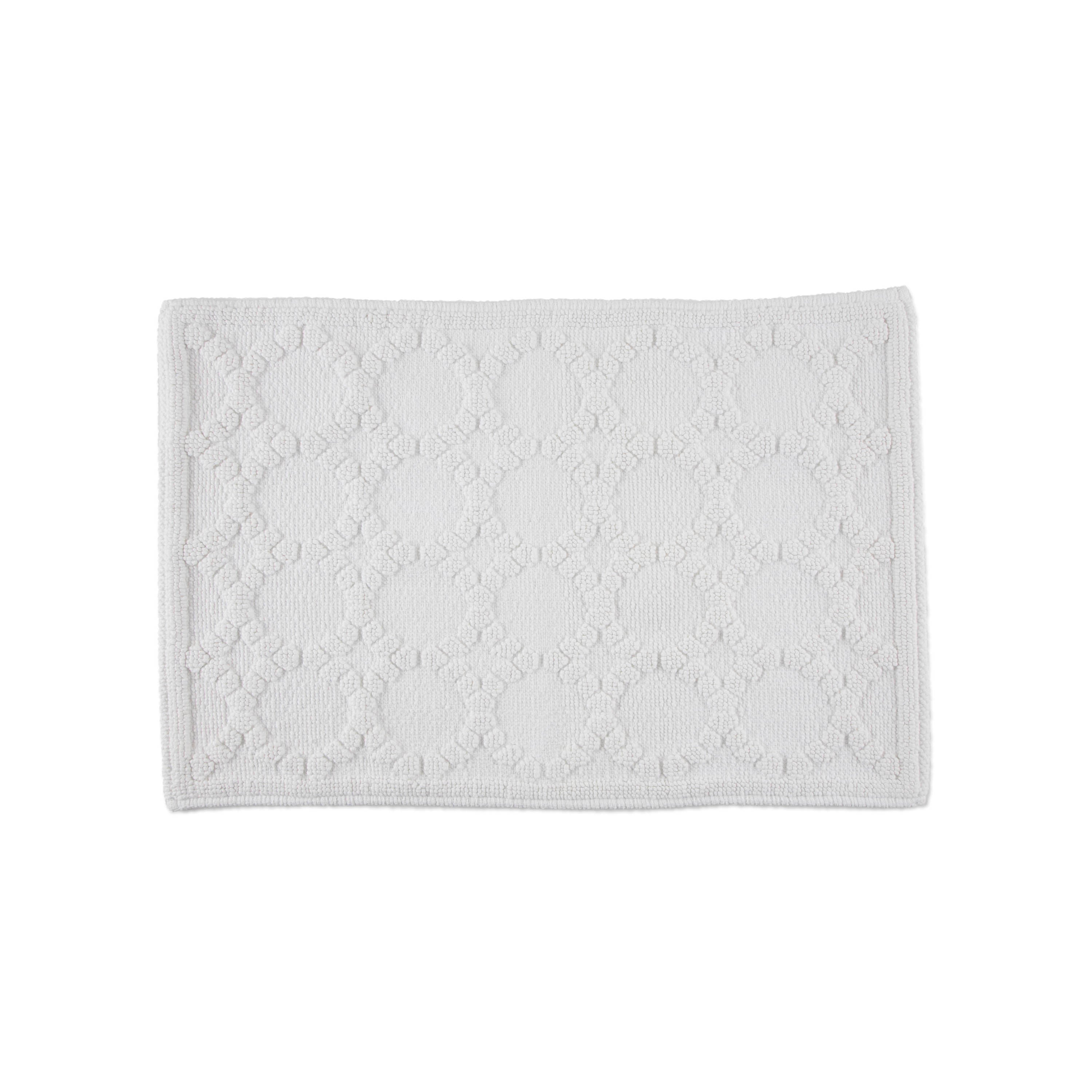 Rectangular white bath rug with a textured circular pattern and a bordered edge.