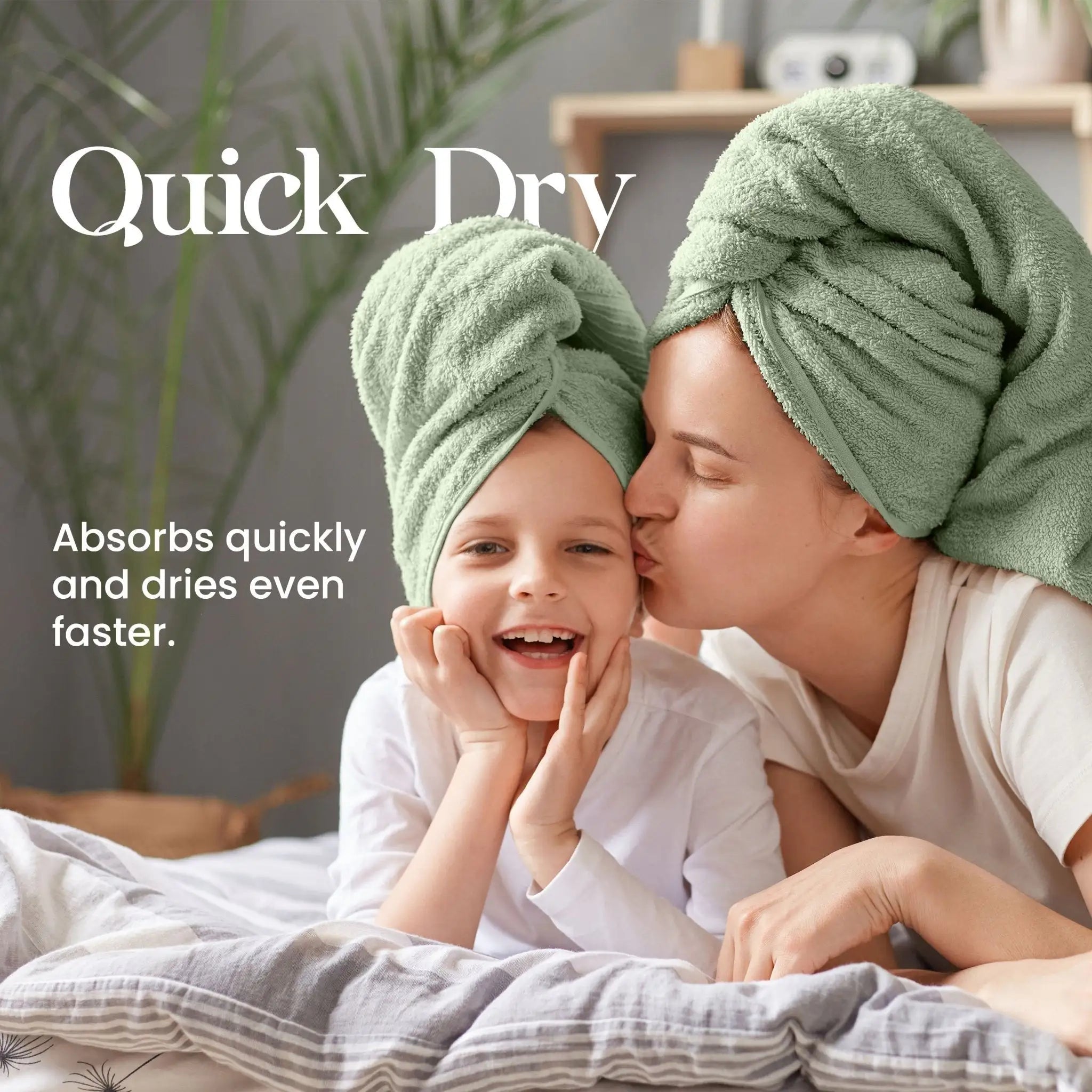 Woman and child with basil towels on heads, lying on a bed with text about quick dry towels.