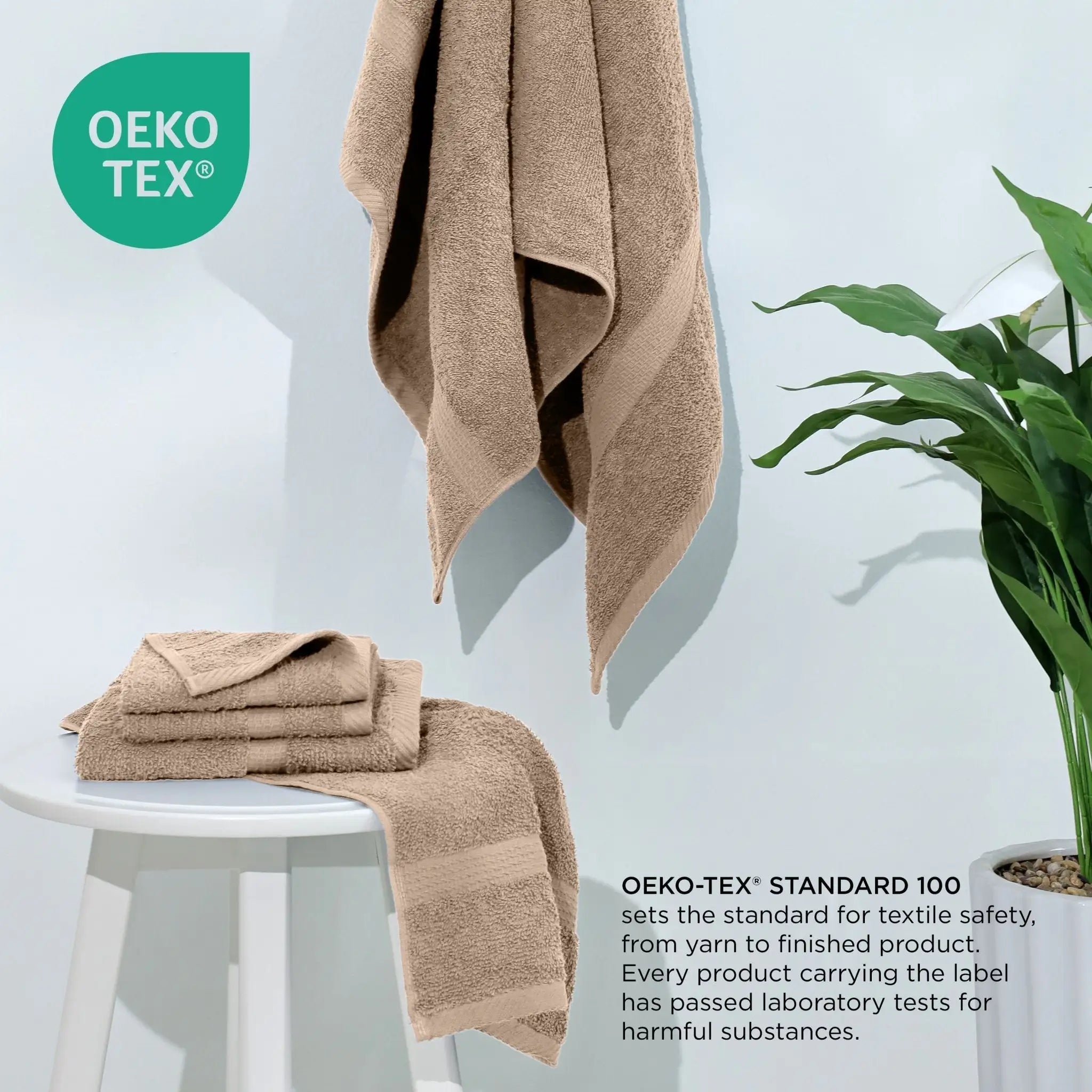Linen towels on a white stool with a plant, featuring the Oeko-Tex logo.