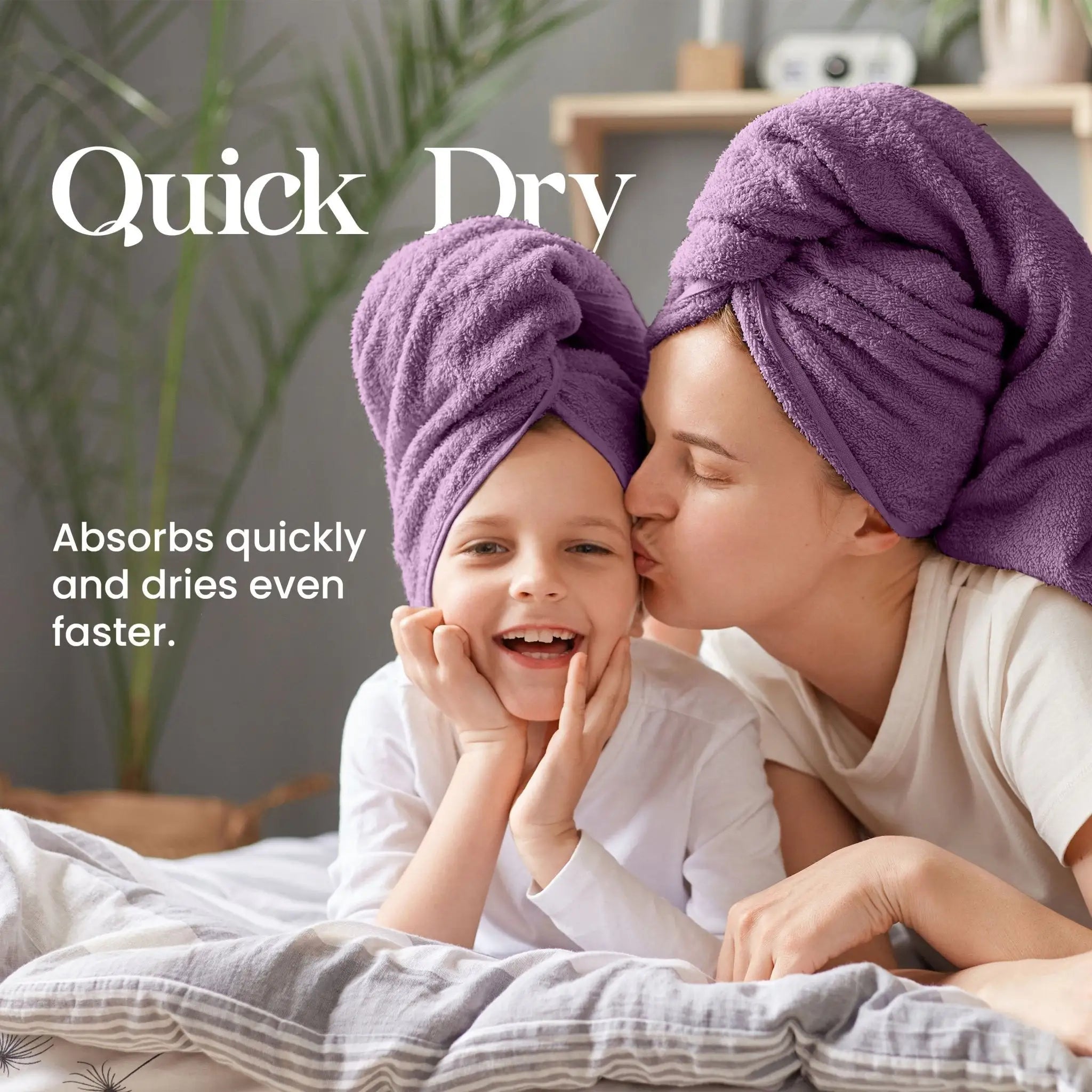Woman and child with purple towels on heads, lying on a bed with text 'Quick Dry' and 'Absorbs quickly and dries even faster.'.