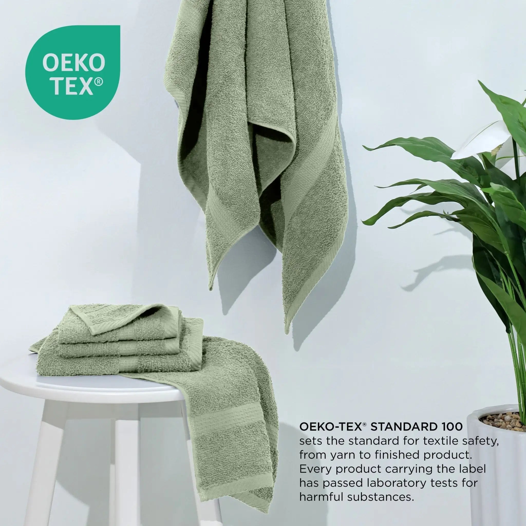 Basil towels on a white stool with a plant, featuring the Oeko-Tex logo.