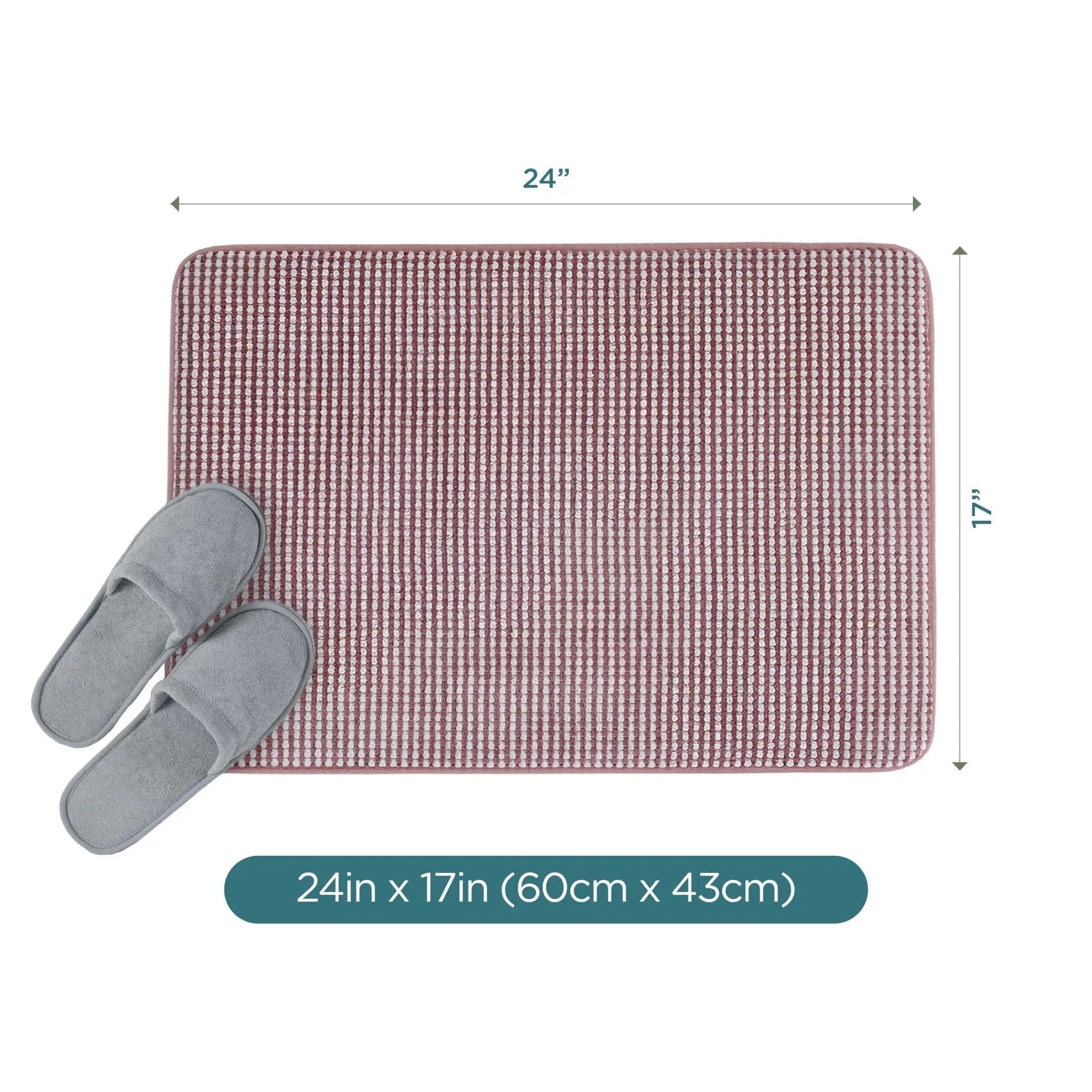 A rectangular berry color bath rug, shown with a pair of gray slippers on a white background. Black dimension lines indicate the mat is 24 inches by 17 inches (60 cm by 43 cm).