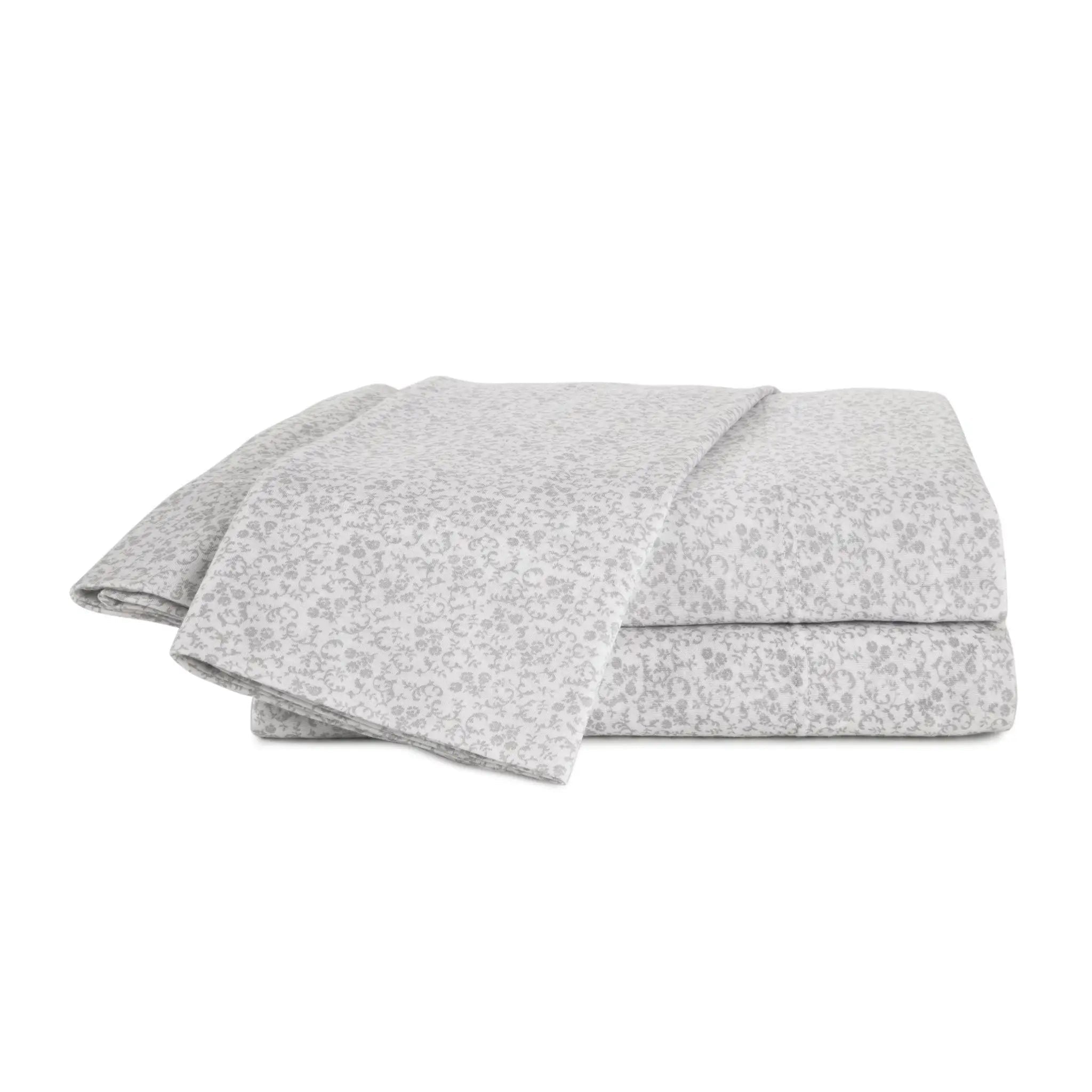 Folded gray sheets with a subtle pattern on a white background