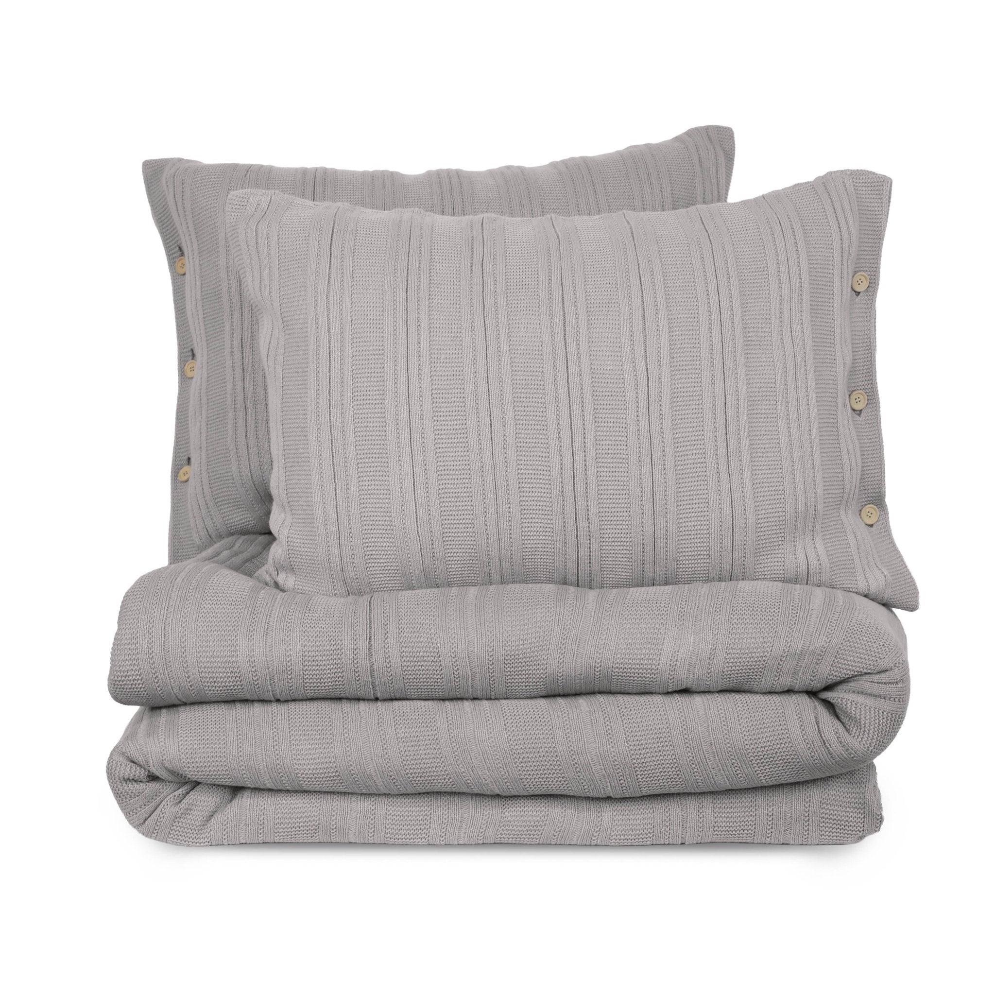 Folded gray textured blanket with two matching pillows on a white background