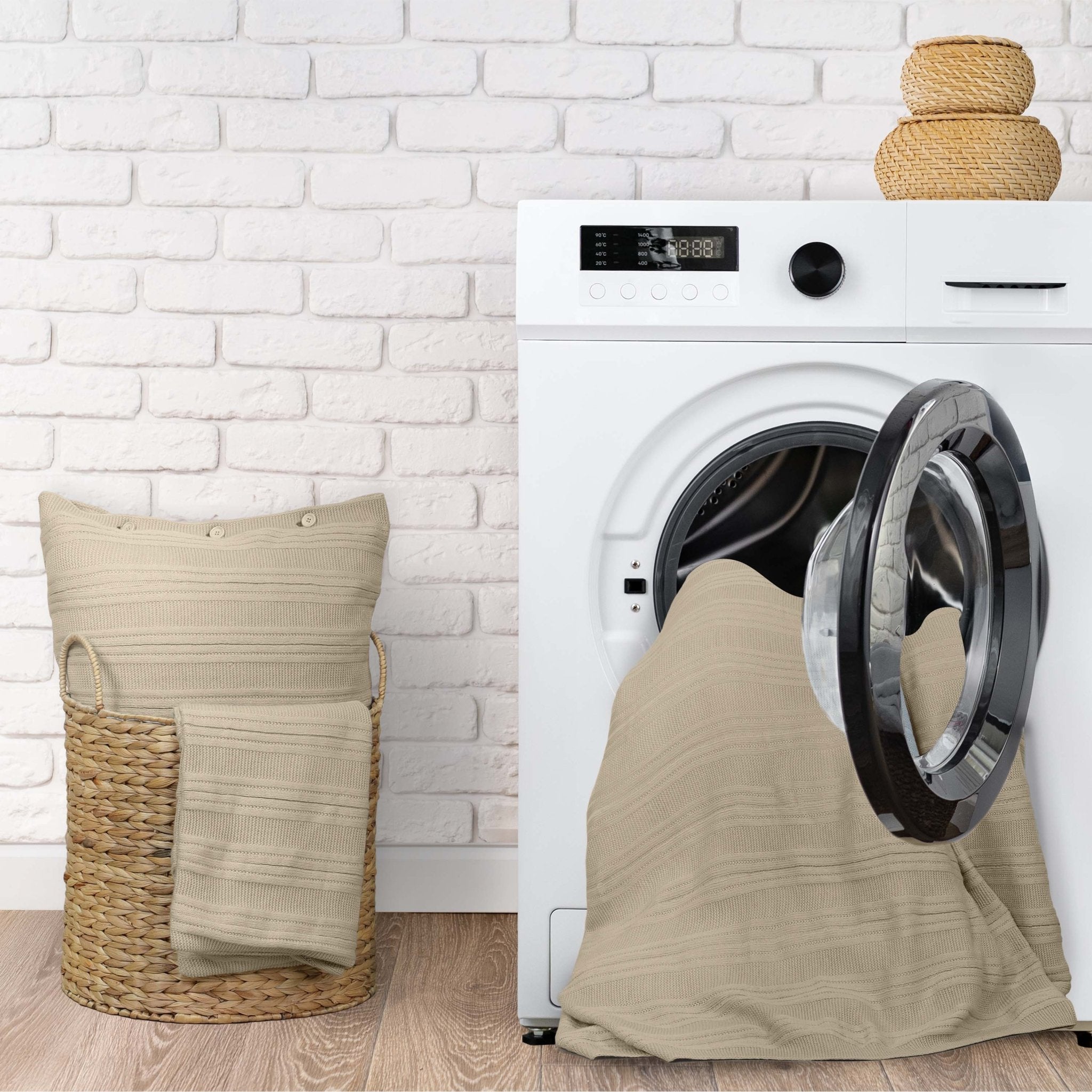 White washing machine with a beige laundry bag draped over it
