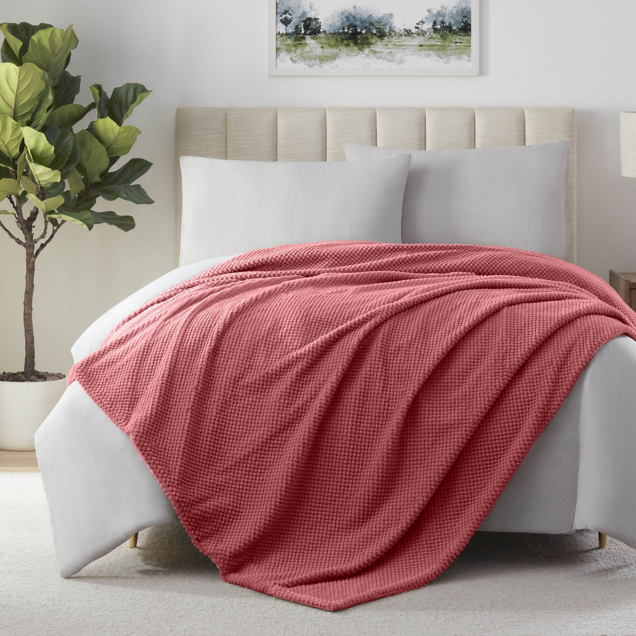 Deep Rose blanket on a bed in a bedroom