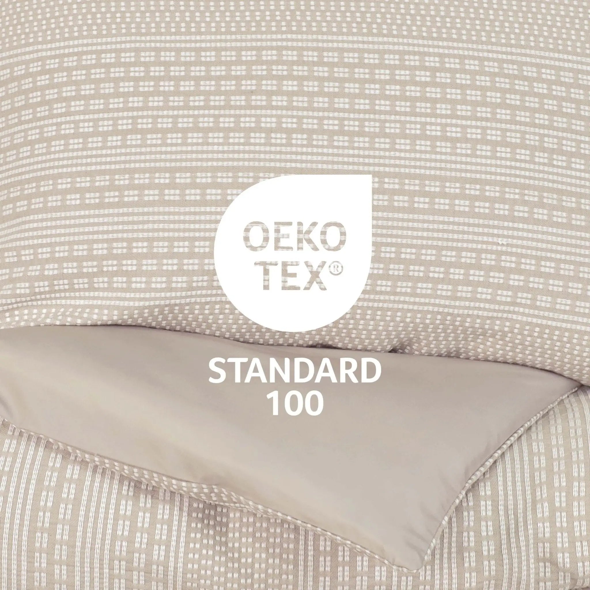 Close-up of a beige comforter set with a white Oeko-TEX Standard 100 certification label overlaid in the center.