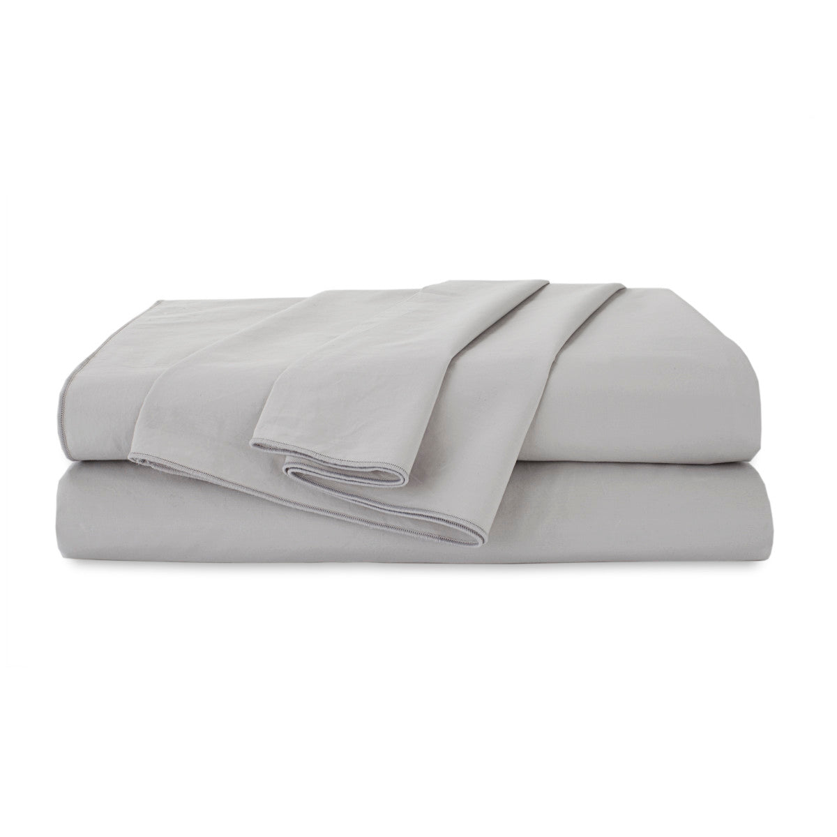 Light gray organic cotton sheet set neatly folded with a smooth texture.