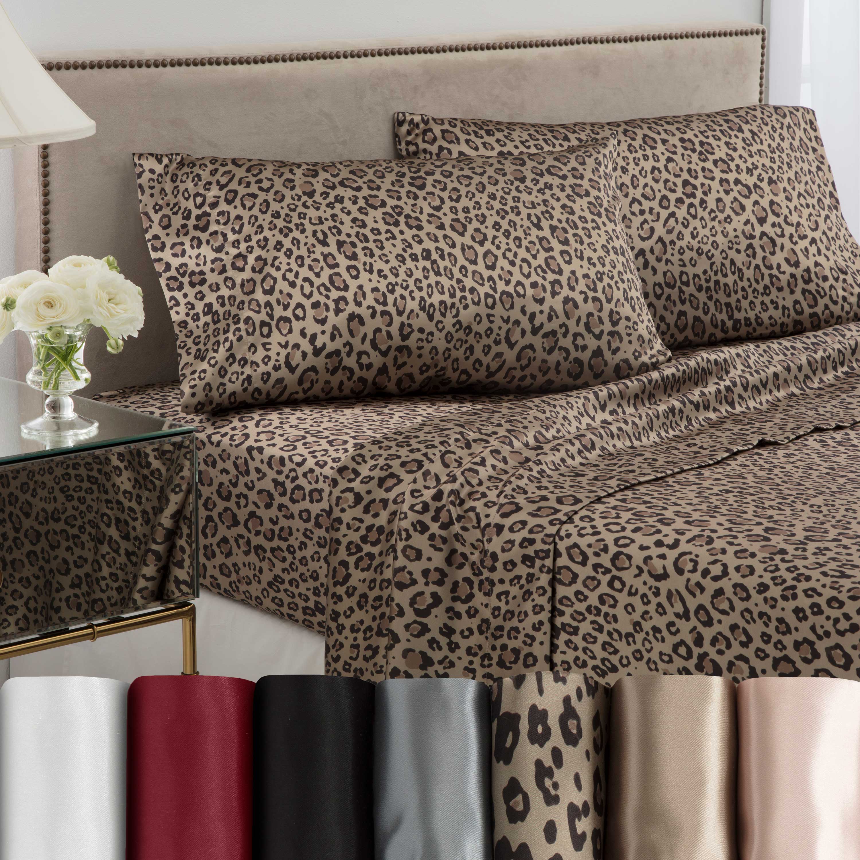 Leopard print satin sheet set displayed on a bed with matching pillowcases and color swatches below.