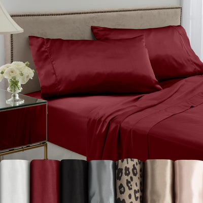 Deep red satin sheet set displayed on a bed with matching pillowcases, alongside various color swatches at the bottom.
