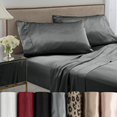 Gray satin sheet set on a bed with two matching pillows, alongside various color swatches at the bottom.