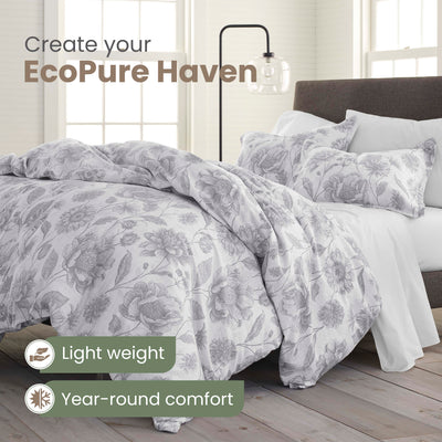 Bed with floral comforter set and text promoting EcoPure Haven, featuring light weight and year-round comfort.