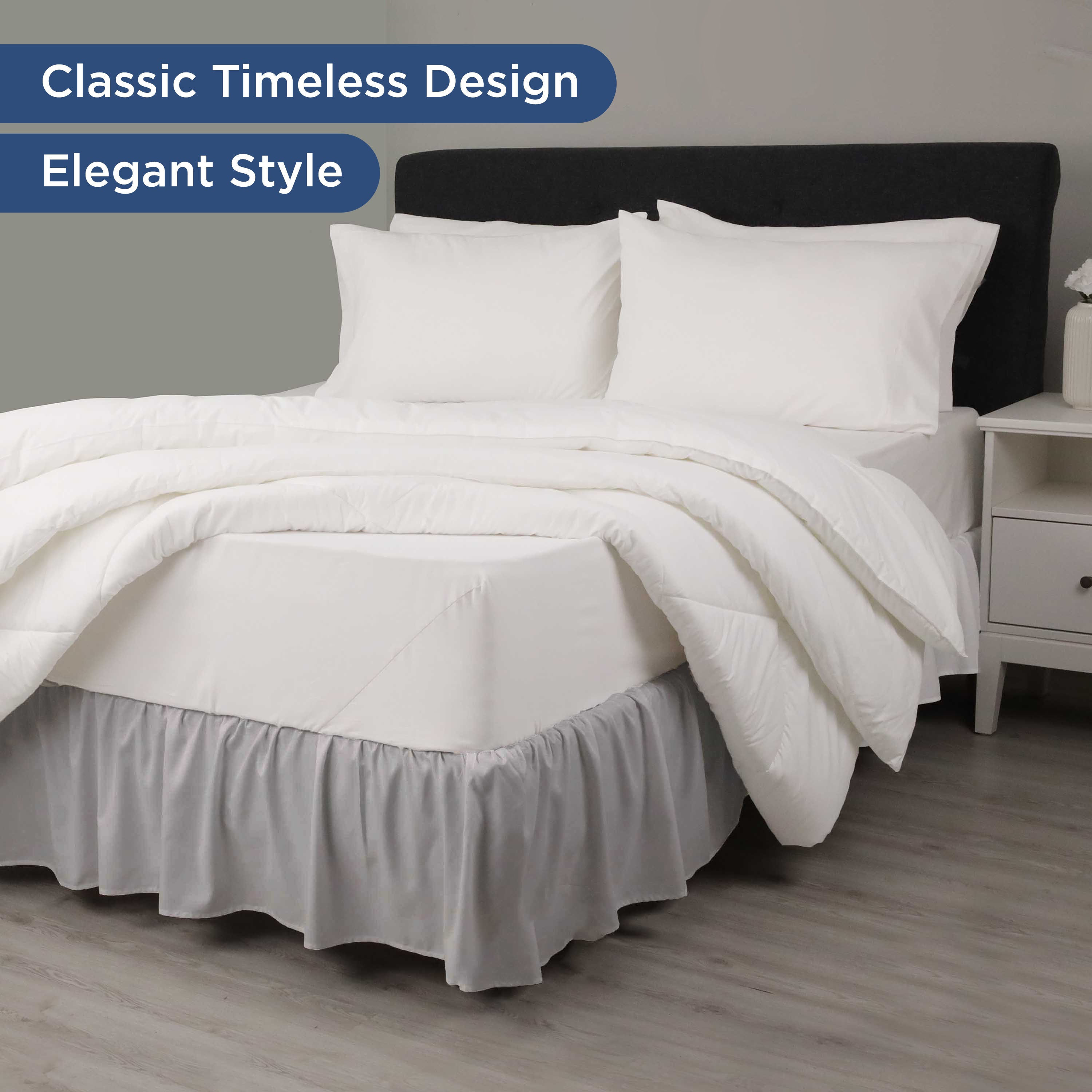 Ruffled bed skirt in gray, paired with white bedding and pillows on a bed with a dark headboard and nightstand.