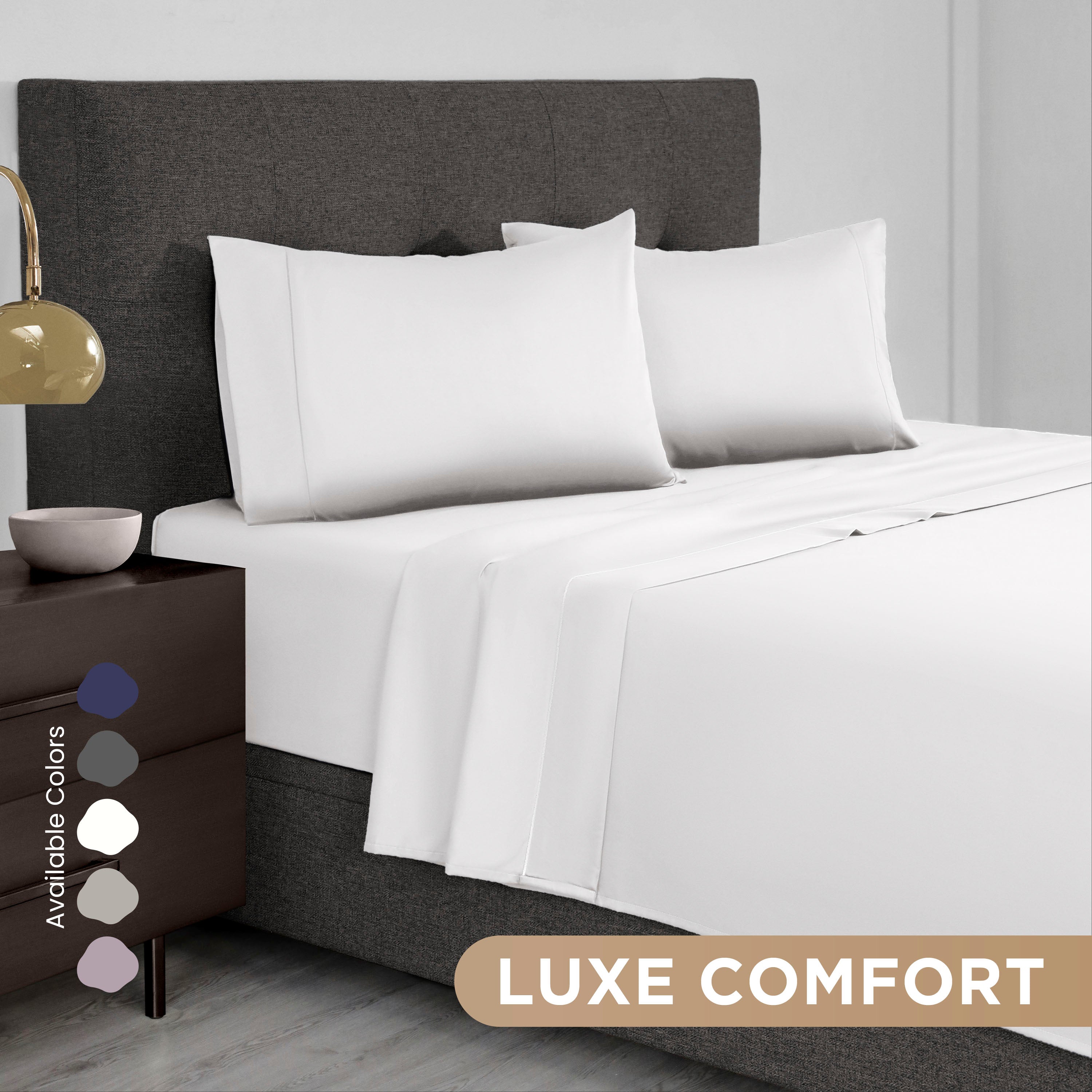 White Supima cotton sheet set on a bed with gray headboard and nightstand, featuring available color swatches.