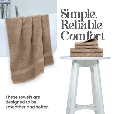 Two beige towels hang over a white tub, with a stack of four folded towels on a white stool nearby.