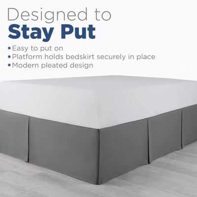 Gray bed skirt with a modern pleated design, fitting securely around the base of a mattress.