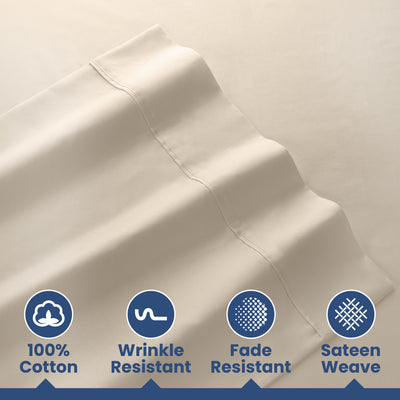 Light beige cotton sheets with a smooth texture and stitched detailing, featuring icons for care instructions.