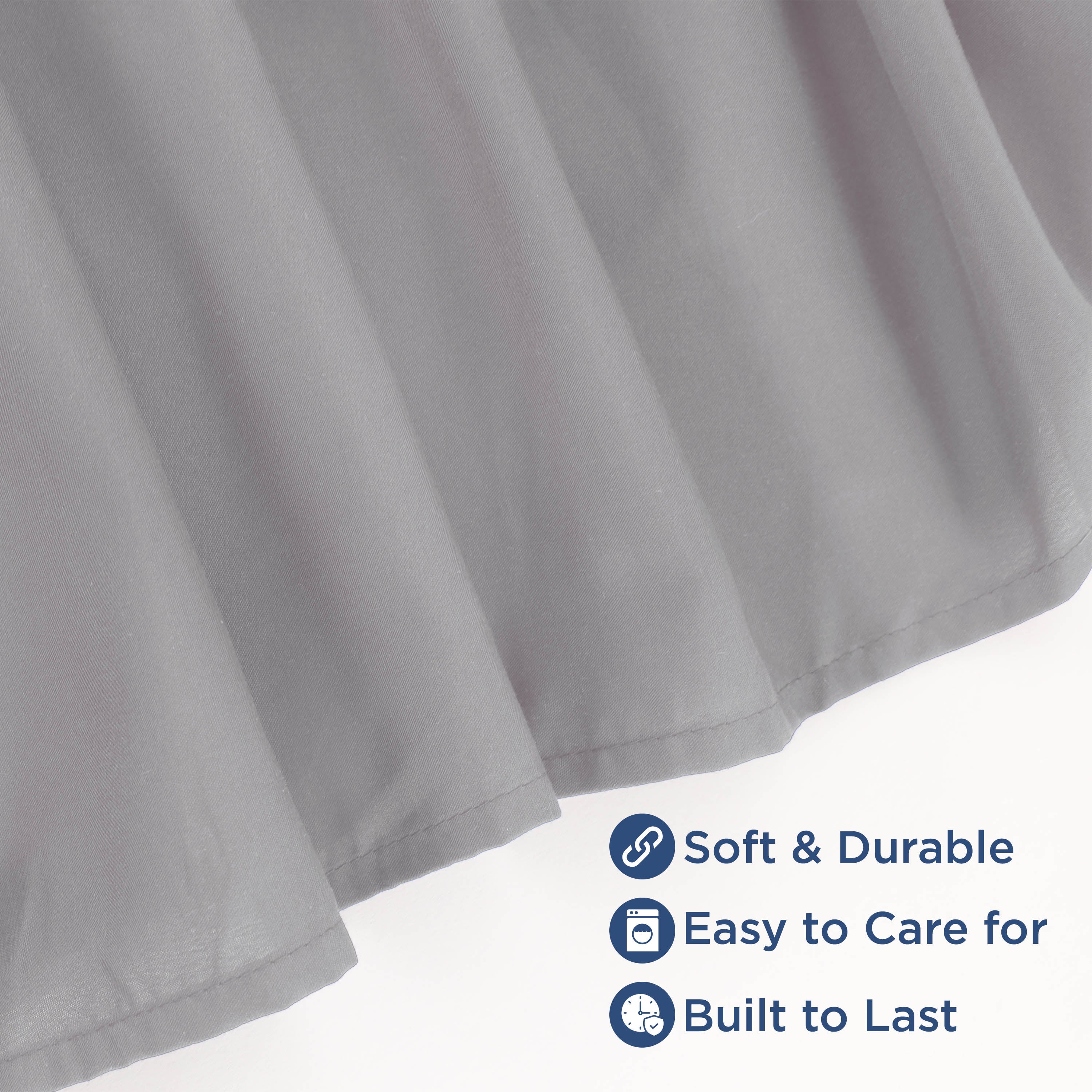Gray ruffle bed skirt with soft fabric and durable finish, featuring care instructions and quality indicators.