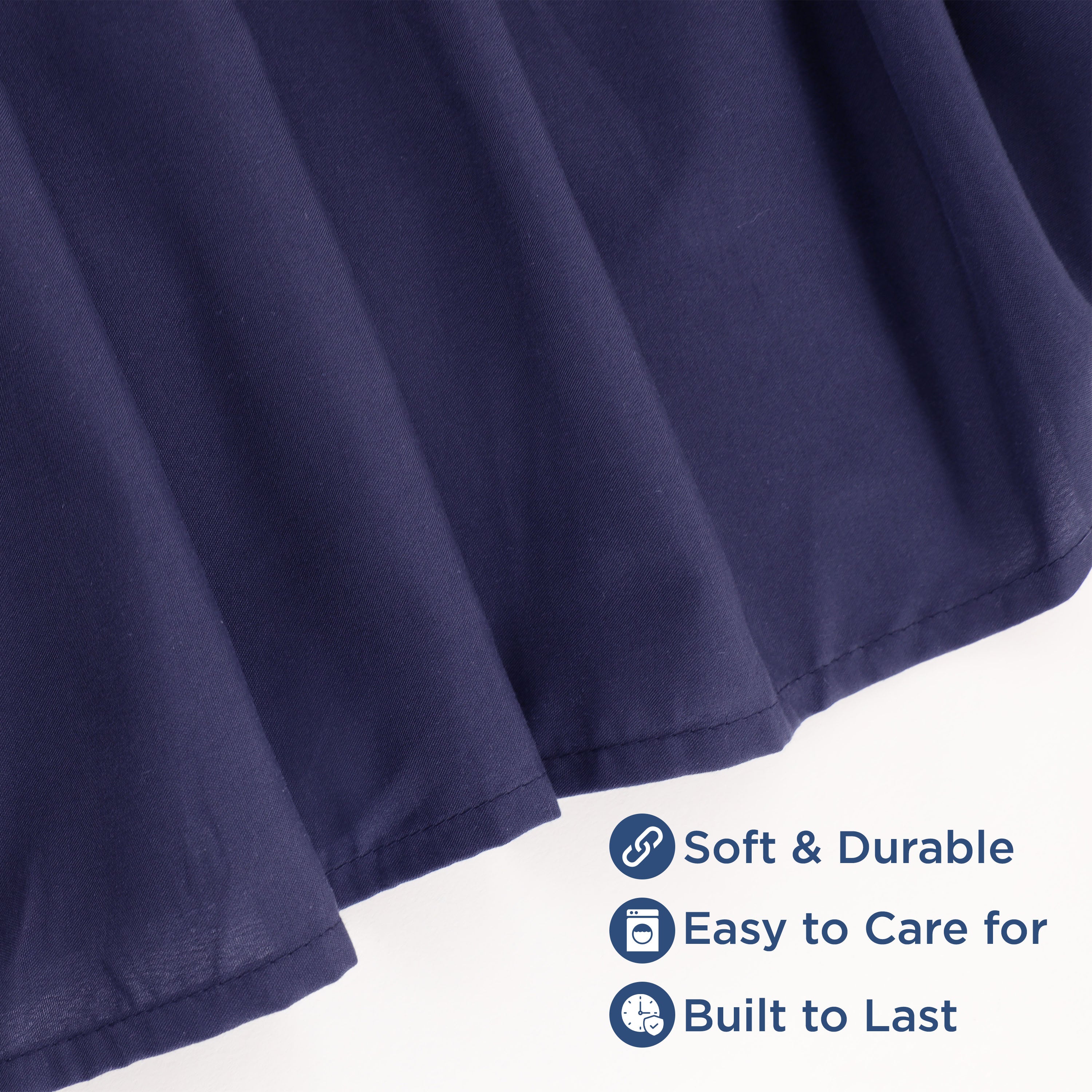 Navy ruffle bed skirt with a soft texture and durable fabric, featuring a hemmed edge.
