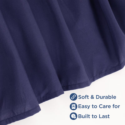 Navy ruffle bed skirt with a soft texture and durable fabric, featuring a hemmed edge.