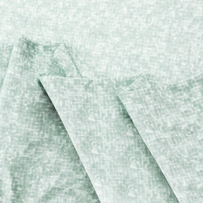 Light green sheet set with a textured, abstract pattern.