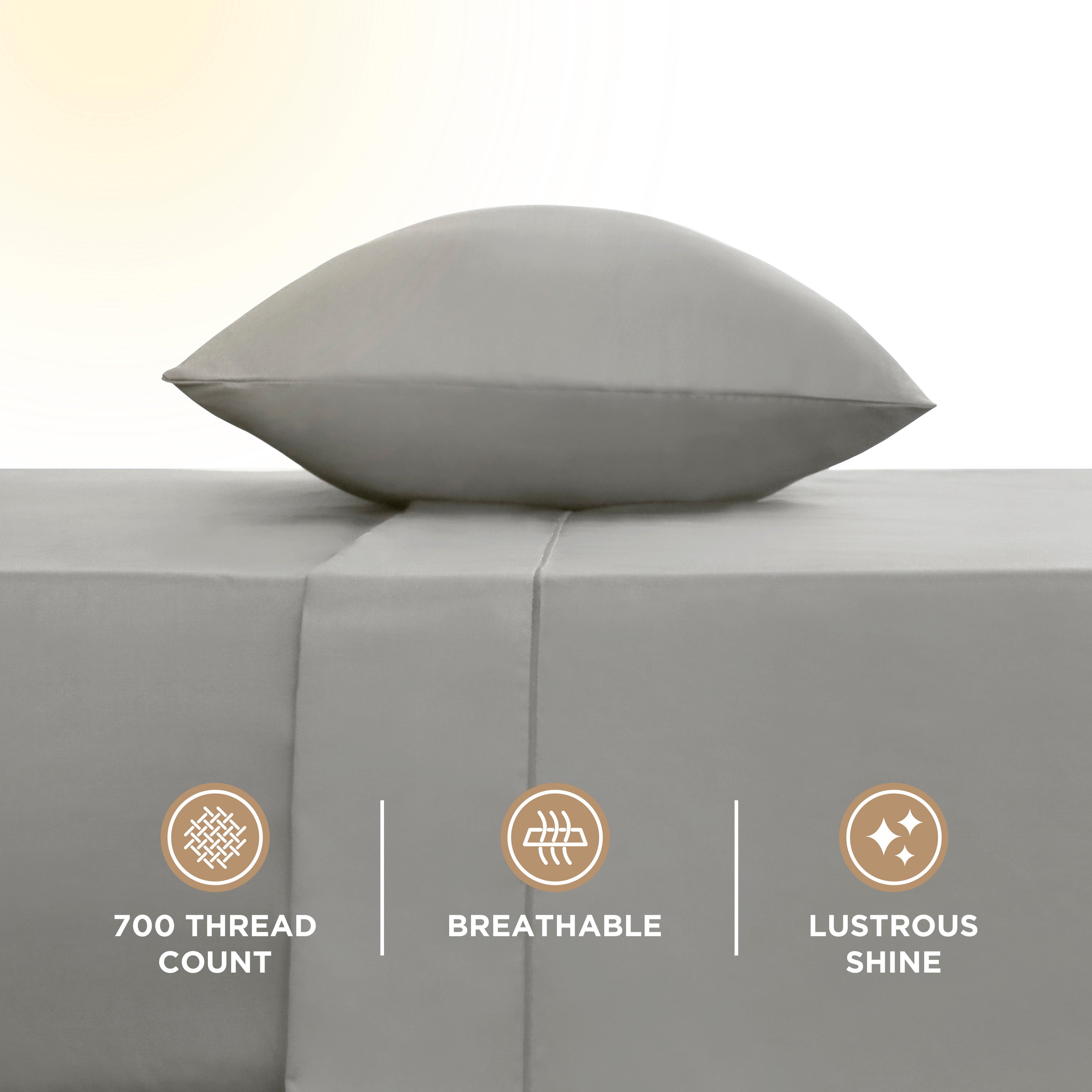 Gray sheet set with a pillow on top, featuring a smooth surface and visible stitching detail.