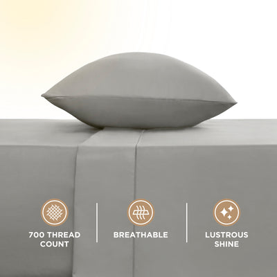 Gray sheet set with a pillow on top, featuring a smooth surface and visible stitching detail.