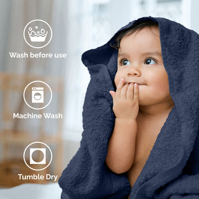 A child wrapped in a dark towel with icons indicating washing instructions in the background.