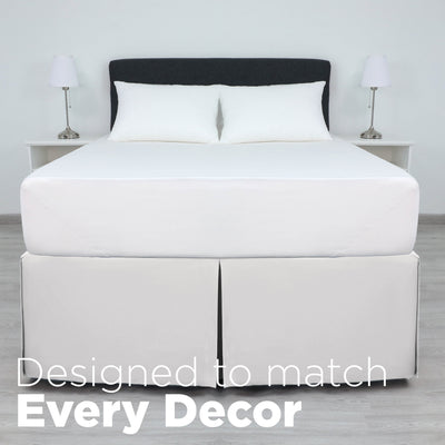 White bed skirt with a 21-inch drop, covering the bed's base, paired with white pillows and a dark headboard.