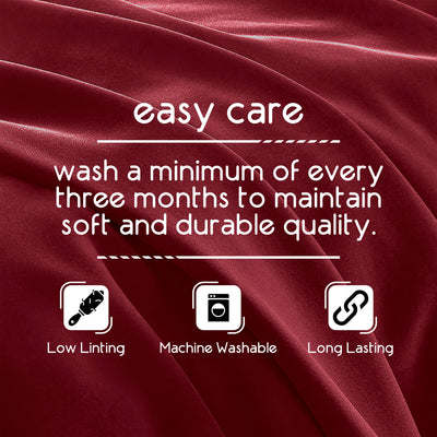 Text on a red fabric background detailing care instructions for a blanket, including washing frequency and features.
